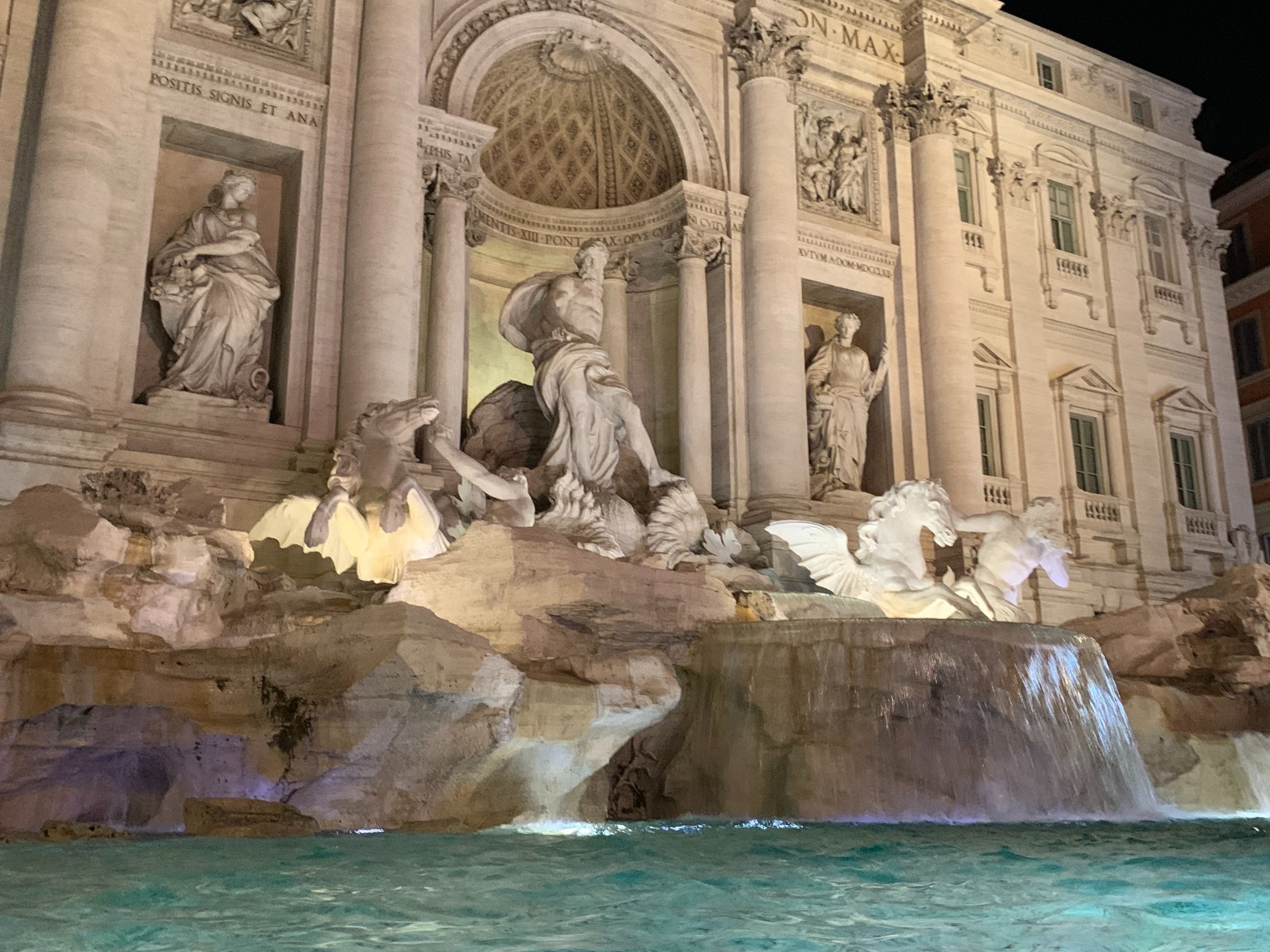 Fountain with statues at night. 