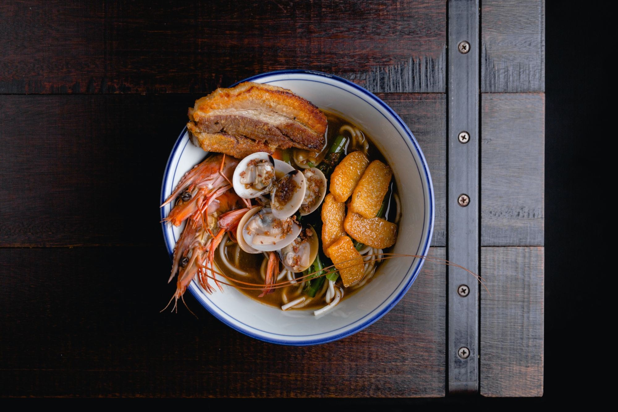 A bowl of soup with seafood. 