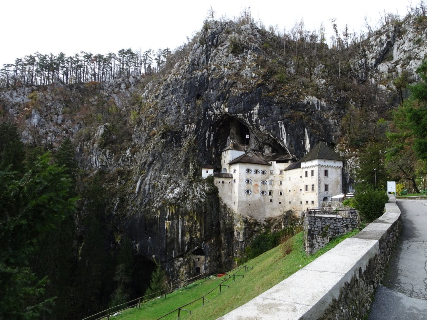 mountain road with white castle at the end