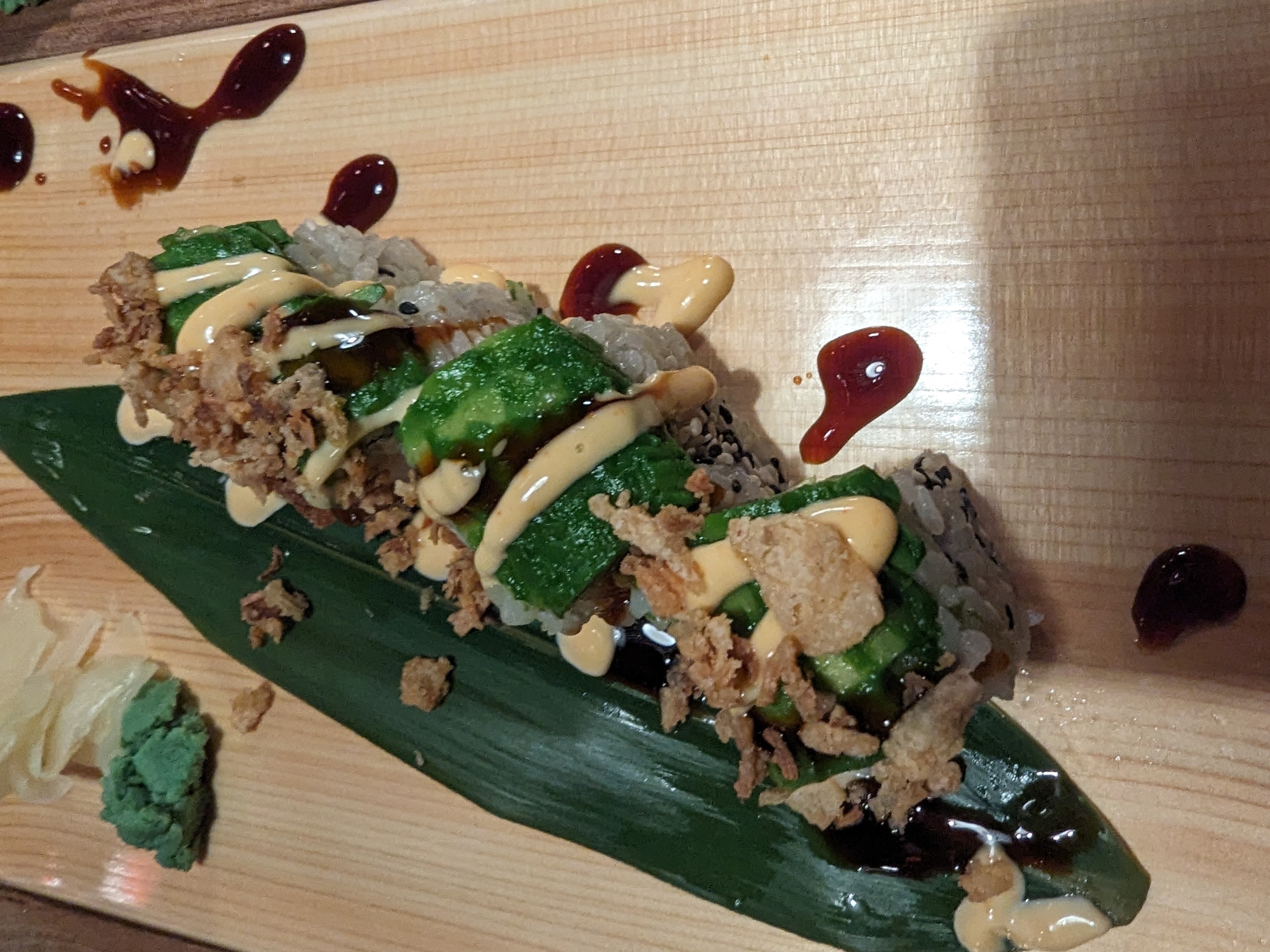 A picture of sushi served on a leaf.