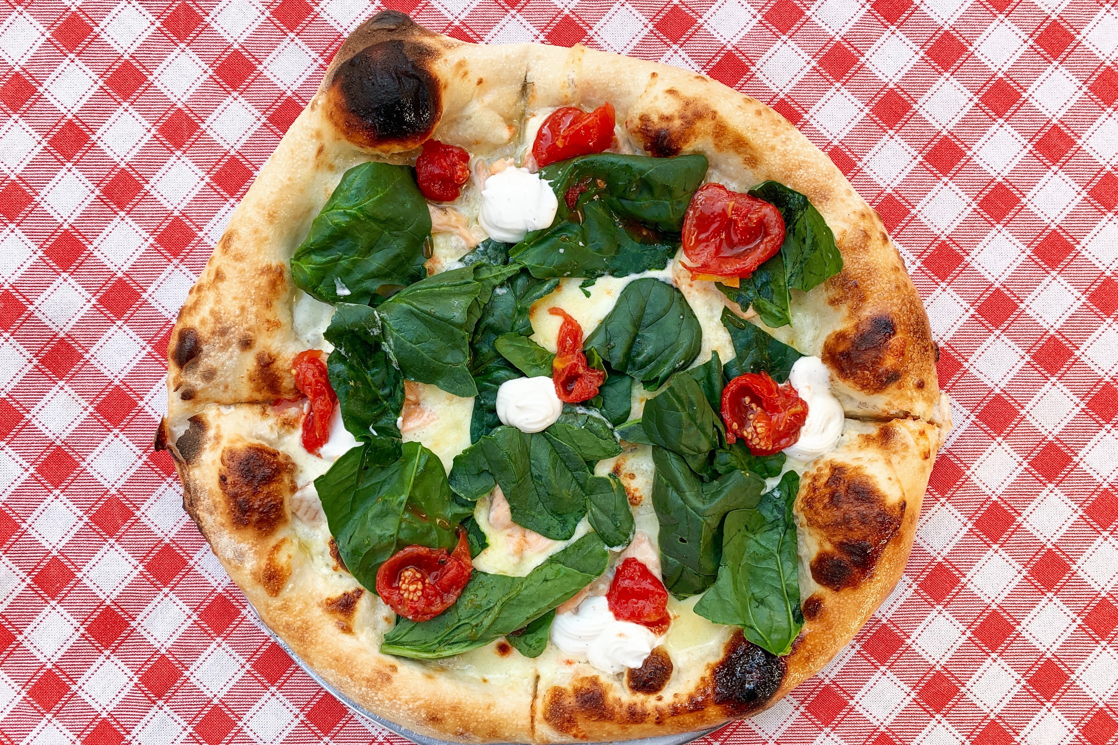 A picture of a pizza served on a table.