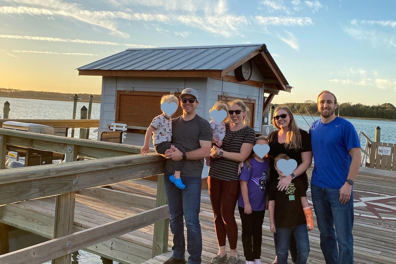 A dockside picture of a family during daytime