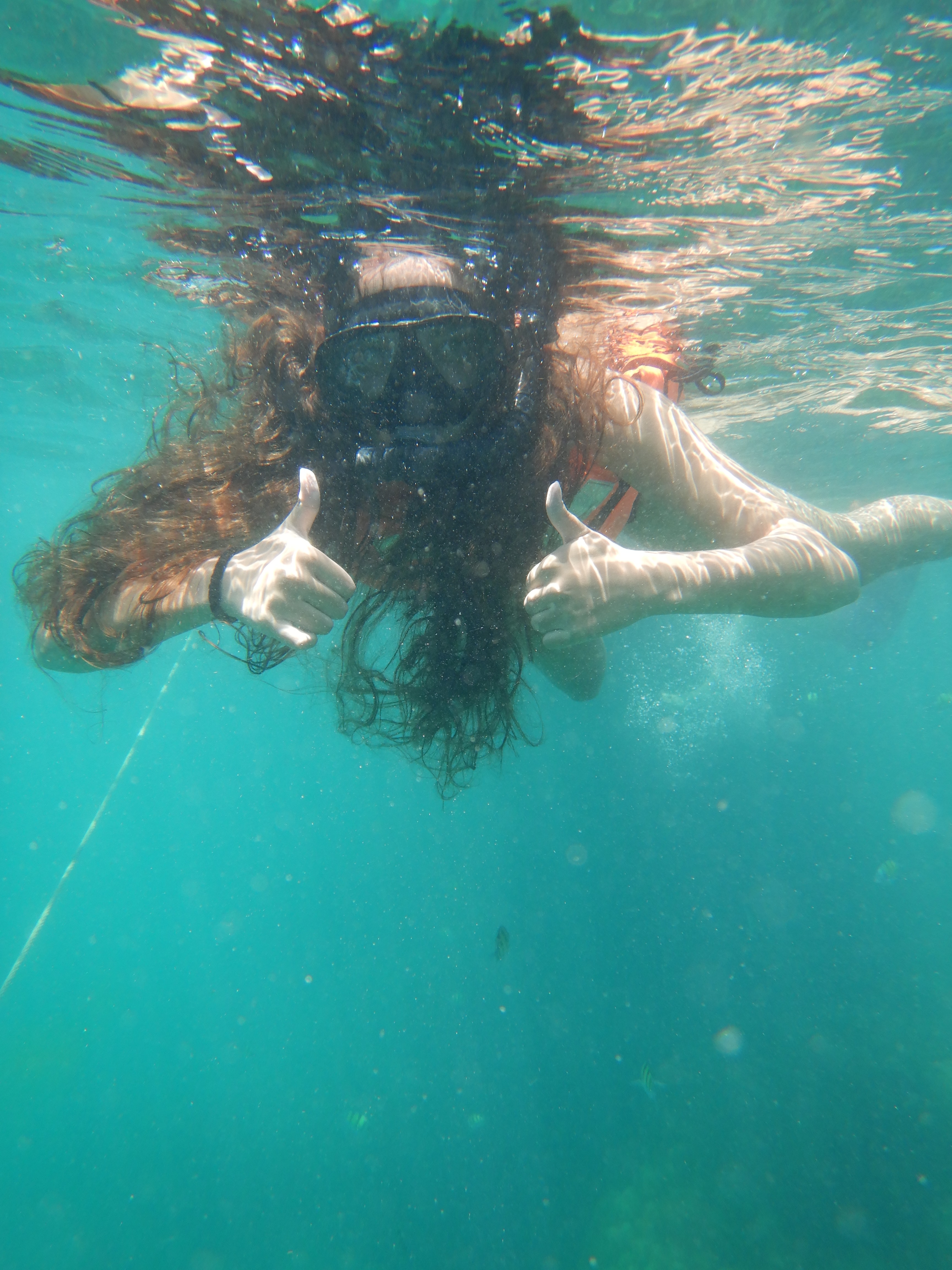 Girl swimming underwater.