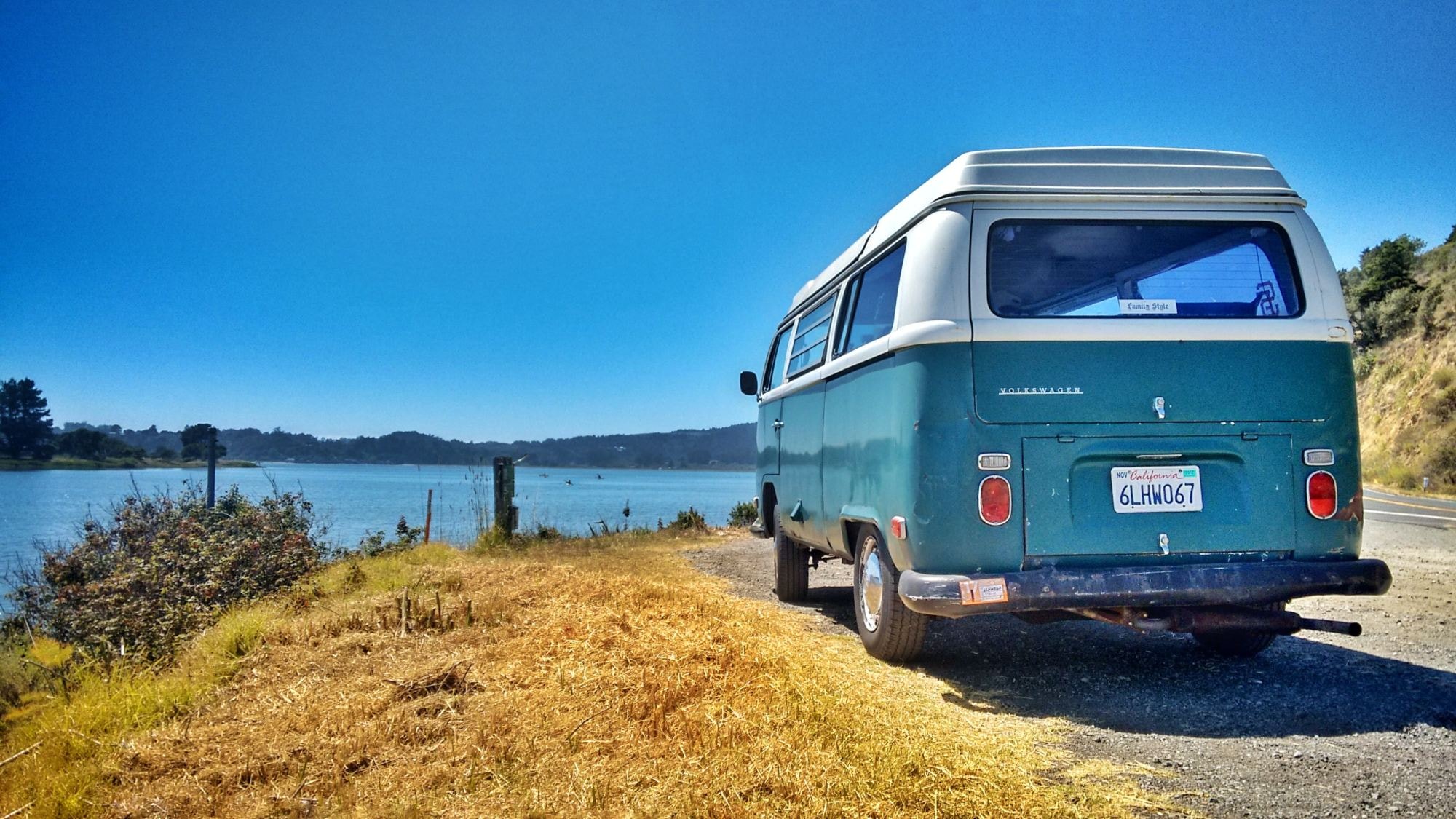 Blue car on a beach.