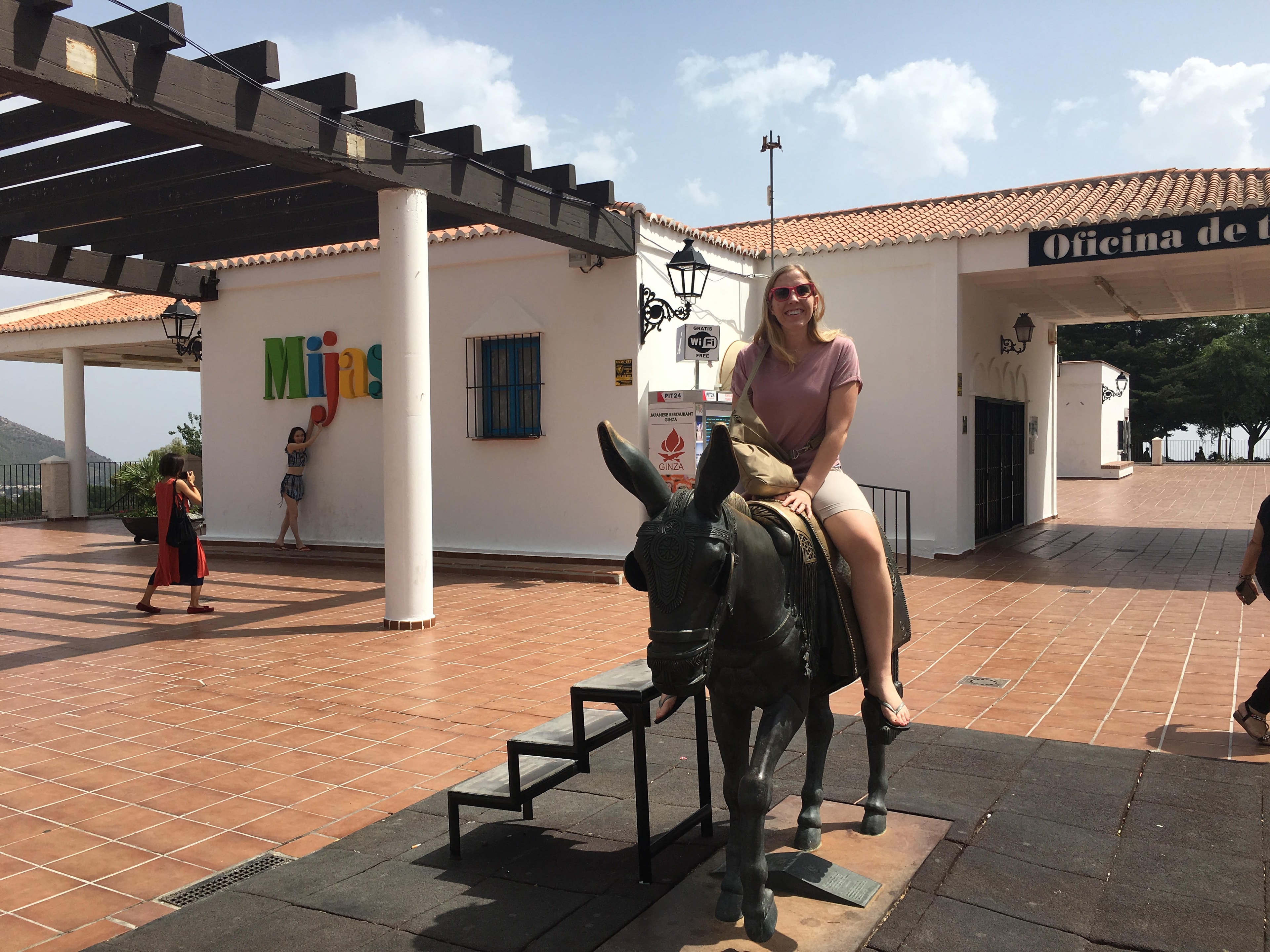 Travel advisor sitting on the back of a donkey