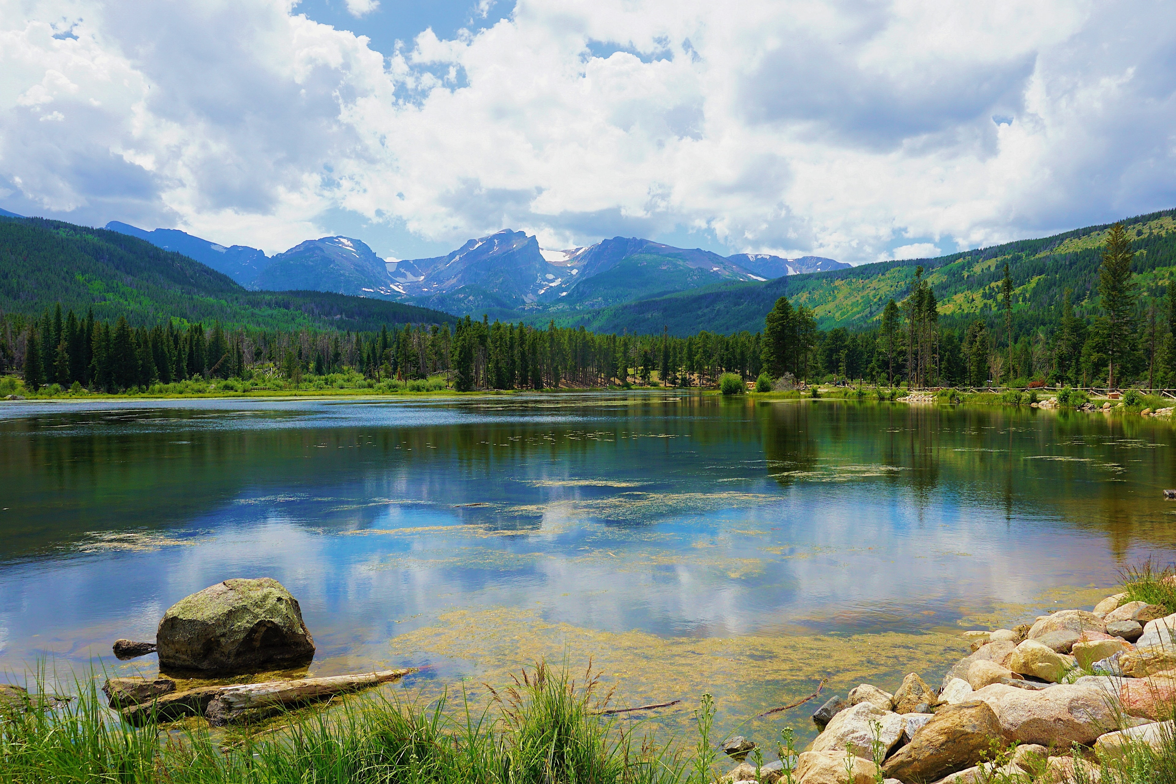 An aerial view of the mountains and a lake during daytime.