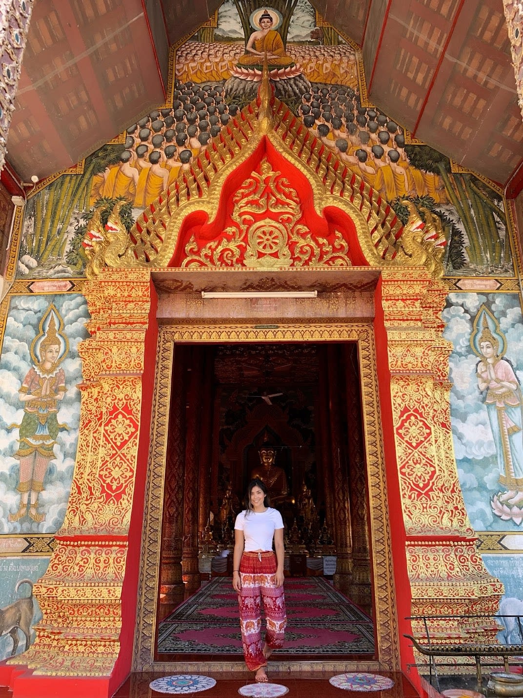 Nicole G posing in an ornate arch way with beautiful colors.