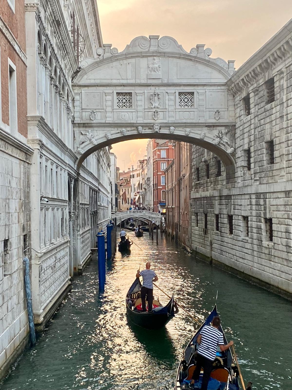 View of the The Bridge of Sighs with two gondolas below from a canal in Venice