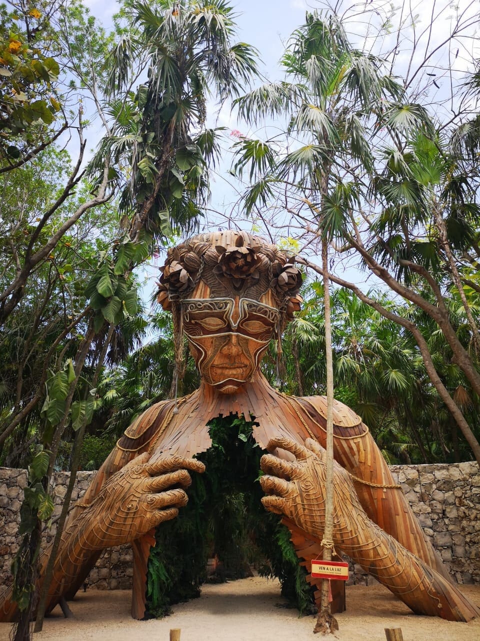 View of a large hollow sculpture of a wooden human figure in Tulum