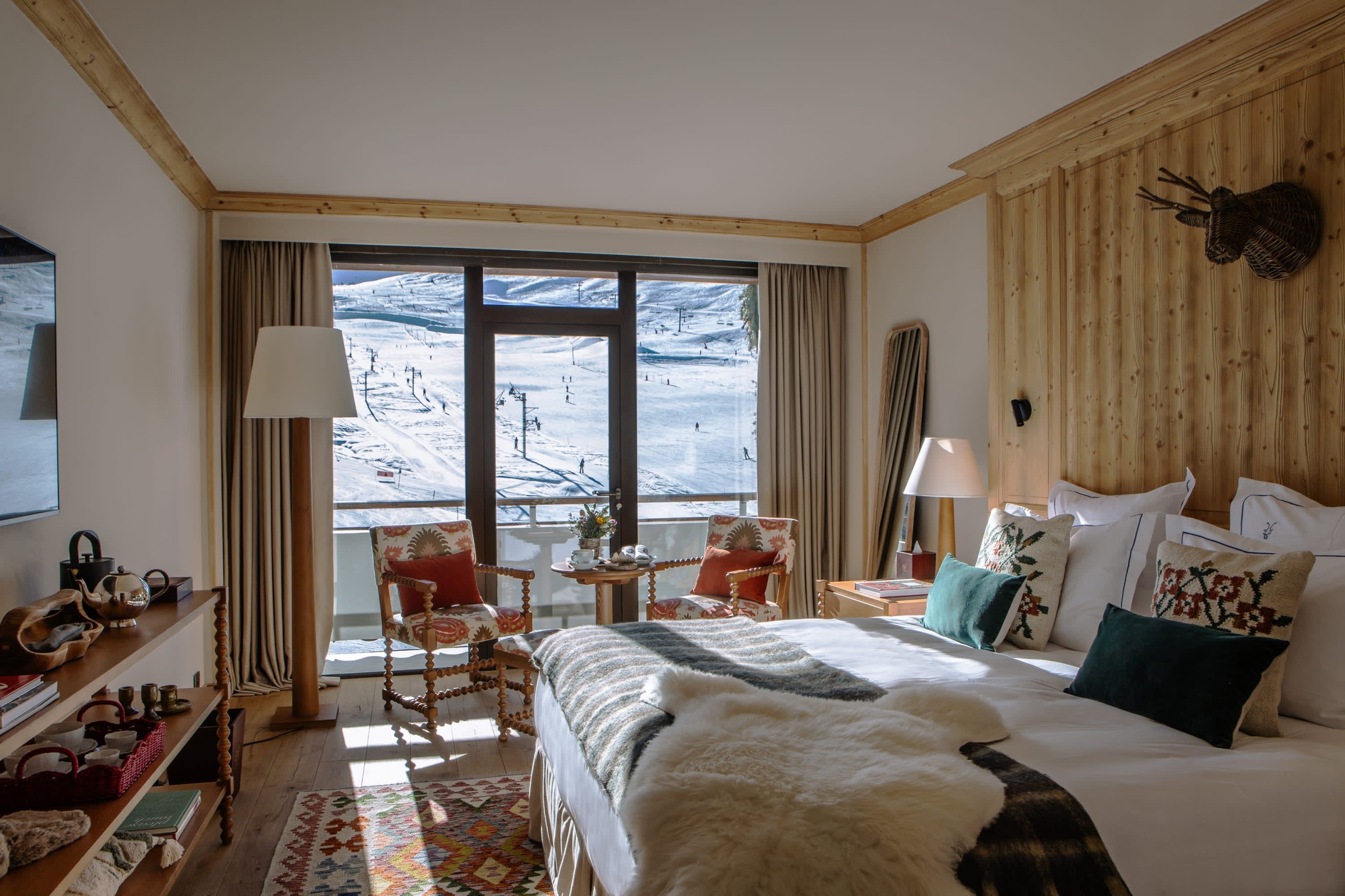 a cozy hotel room overlooking a ski mountain