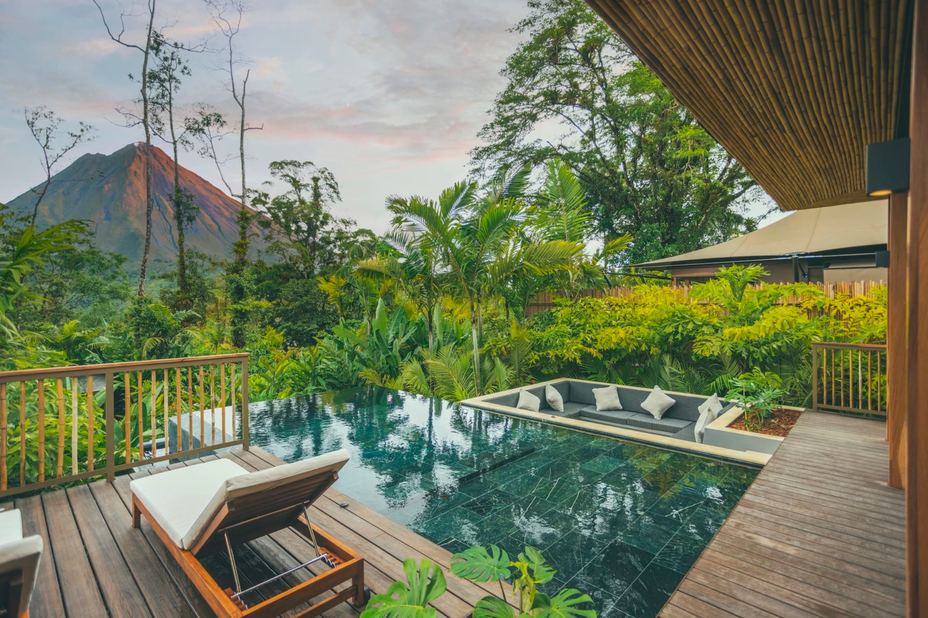 Loungers, a private plunge pool and chic space with plush sofas all overlooking the Costa Rican jungle. In the distance stands Mount Arenal