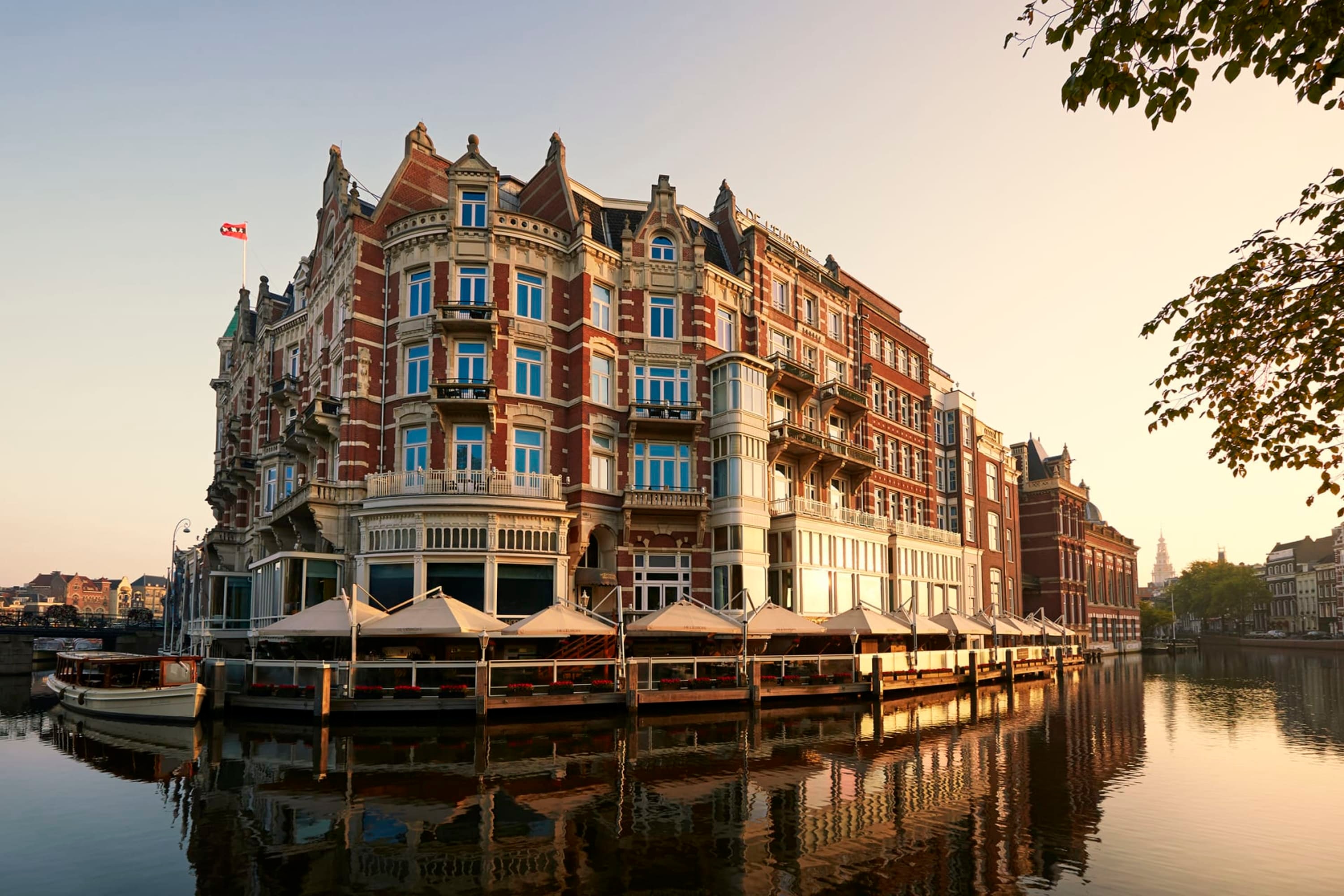 Colorful historical building sitting on a calm canal in Amsterdam