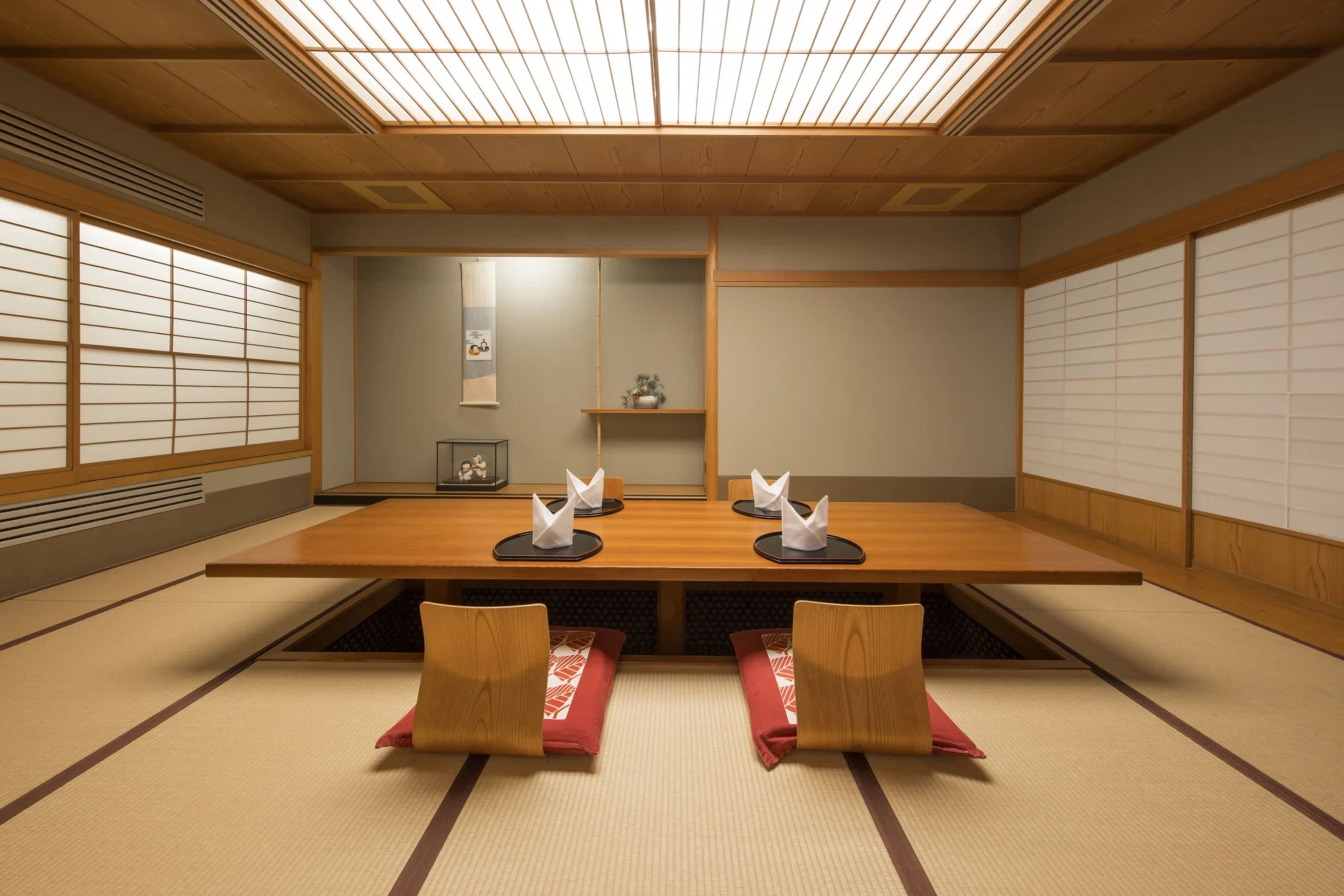 Japanese-inspired dining room with walls painted like Japanese screen walls, floor seating and low hardwood table