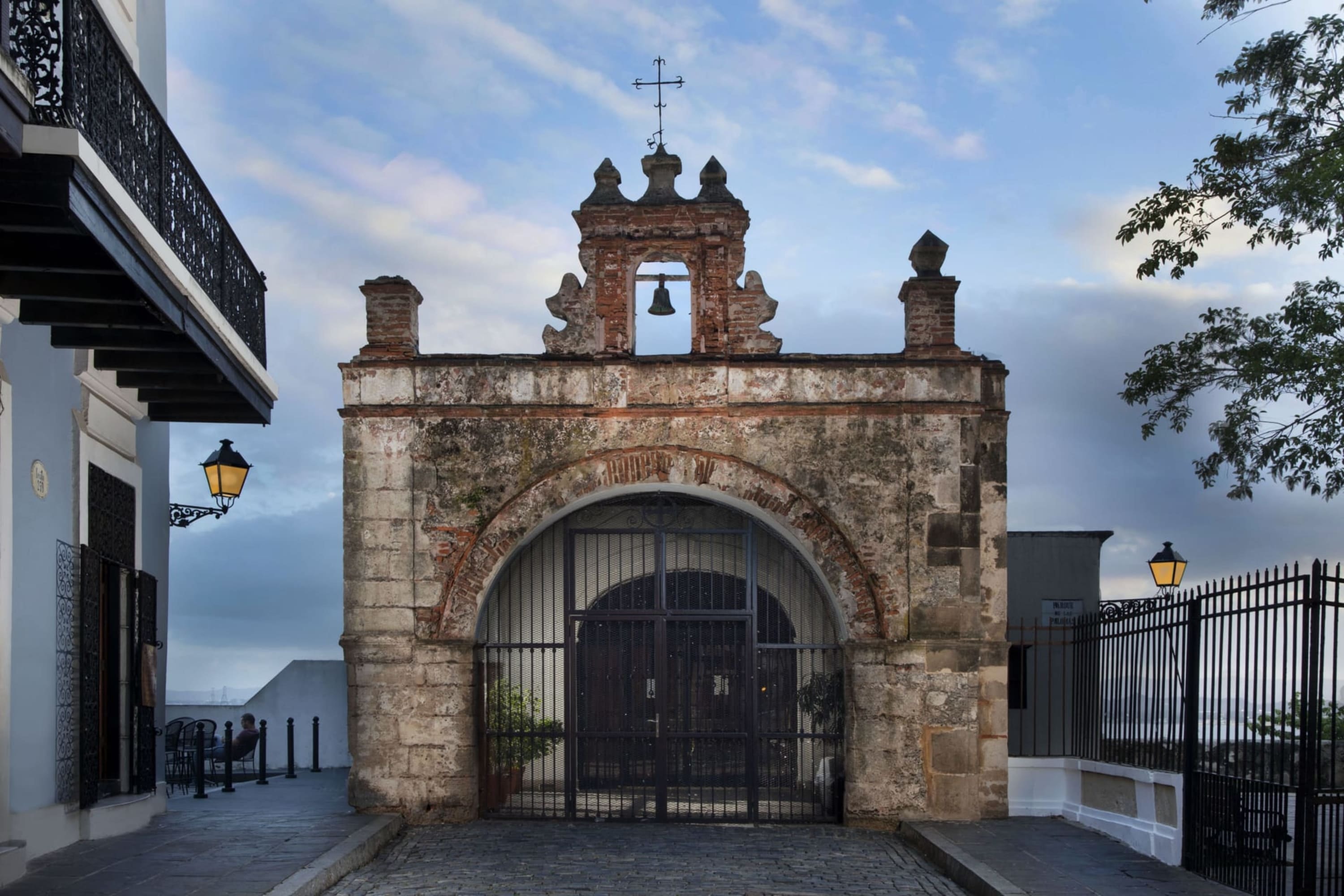 Centuries-old architecture from the original settlement of Old San Juan. The entrance is barred, and the structure is next to a newer Old World building