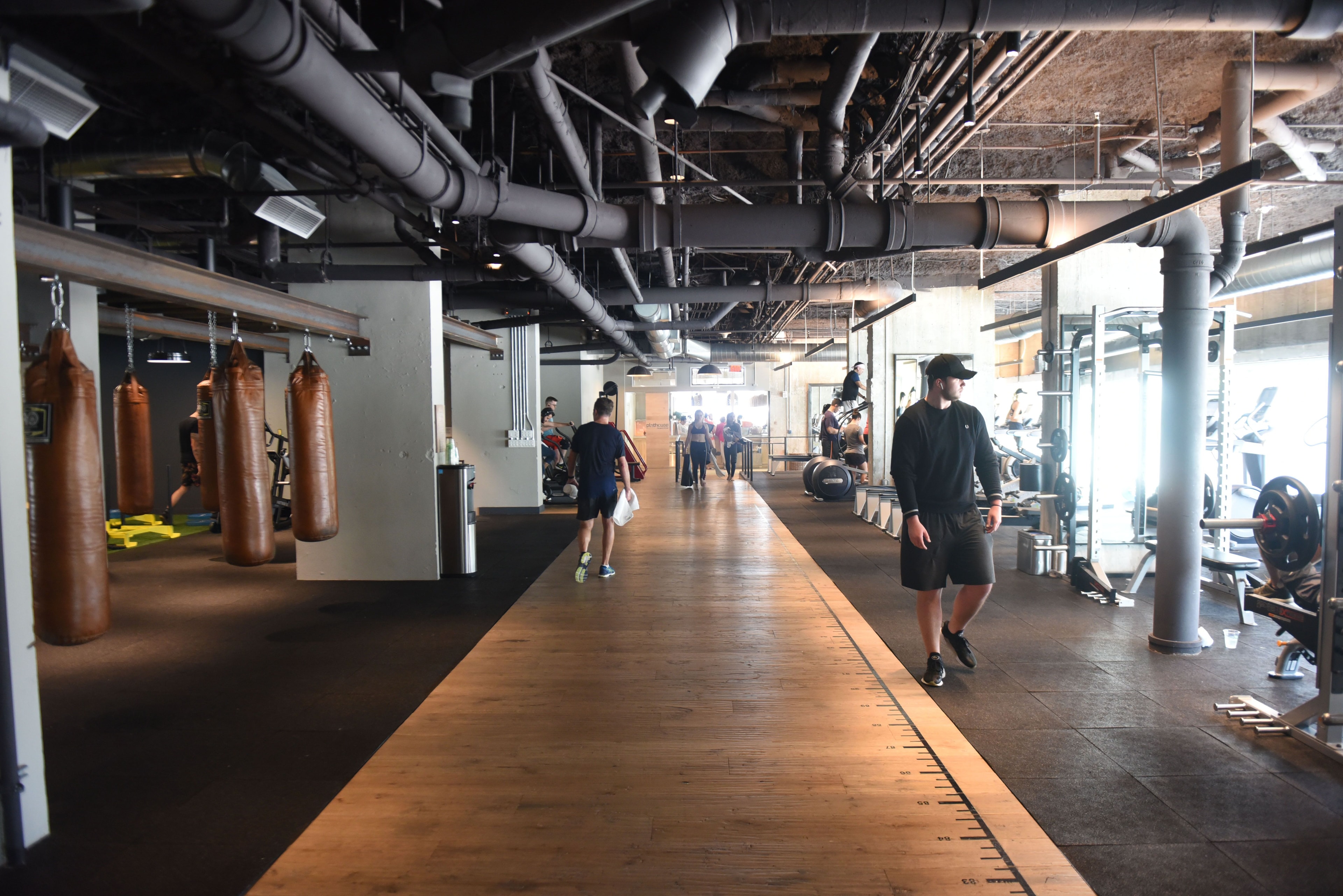 people walking in a modern hotel gym