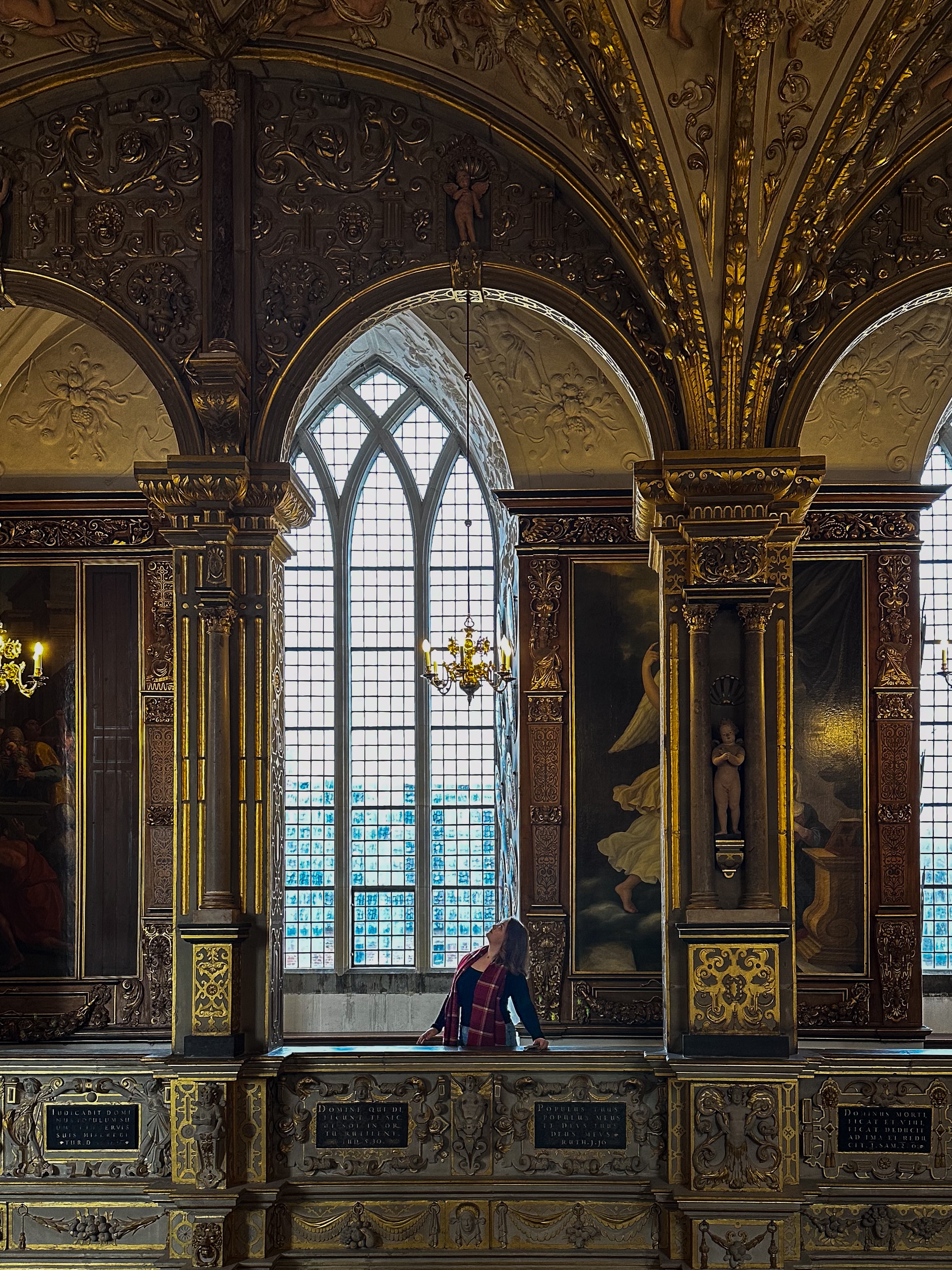 The inside view of a classic building with large windows and an arch way.