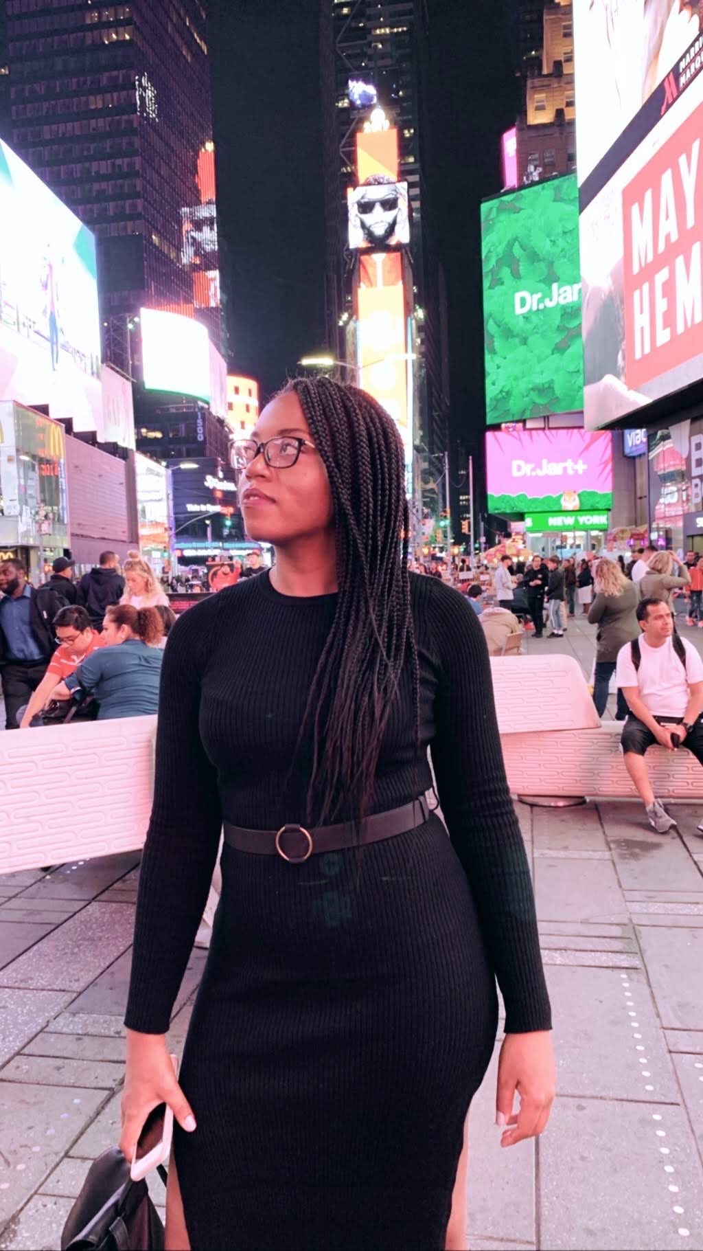 Ashlyn in a black dress in Times Square.