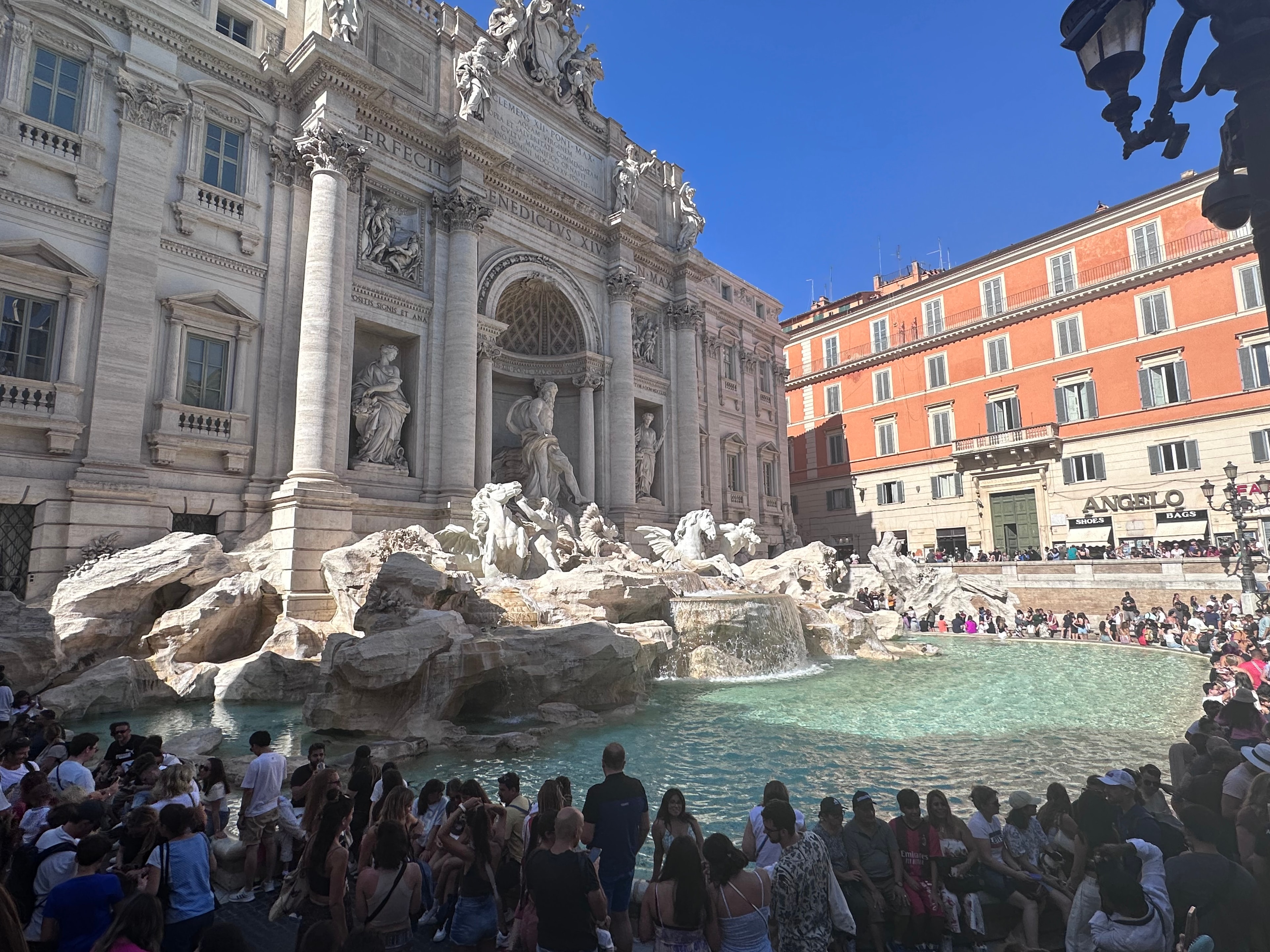 A large fountain in Rome on a sunny day.