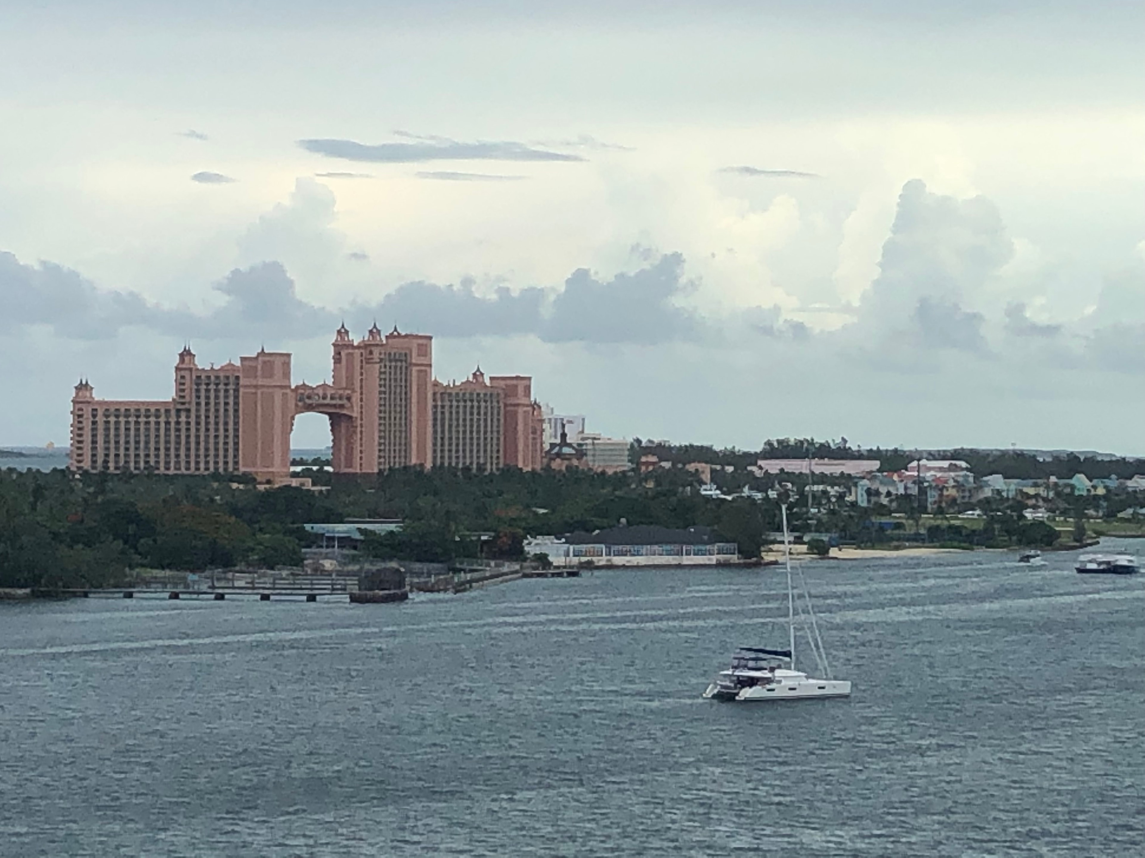 A beautiful view of a waterway with buildings in the distance at dusk. 