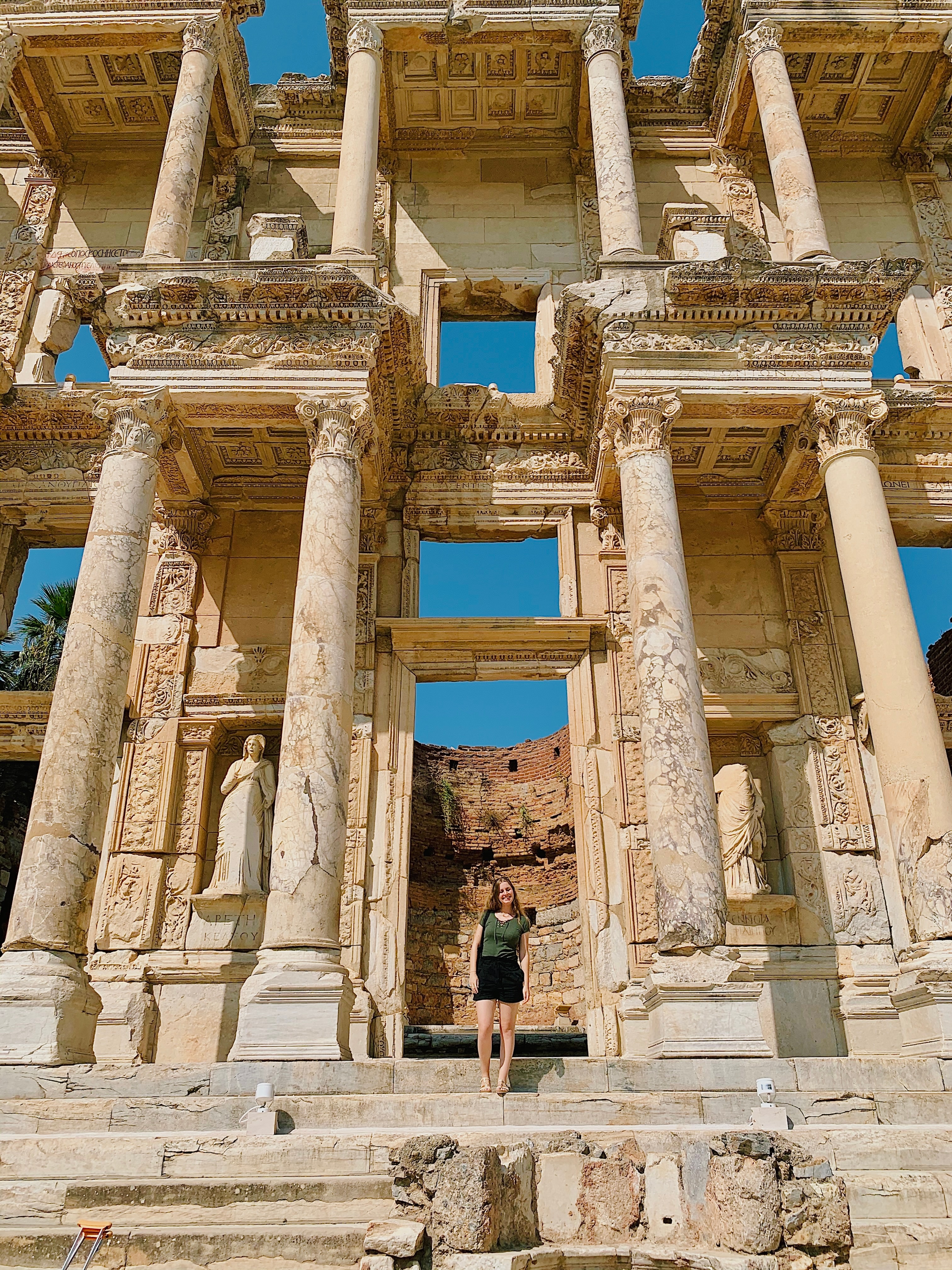 Beautiful view of Kaitlin posing in front of Egyptian ruins on a sunny day