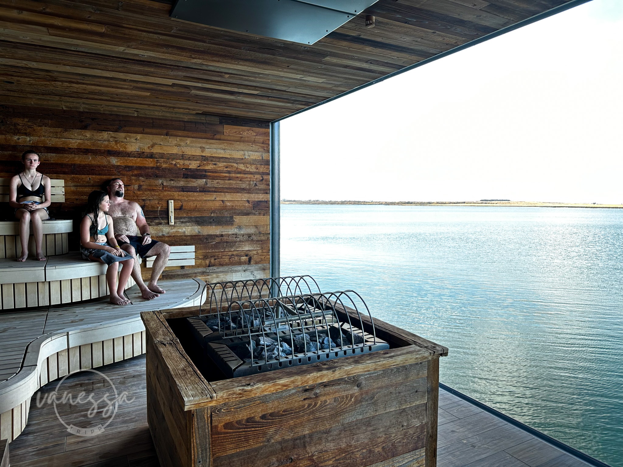 An image of a steam room with a window view of the ocean in the distance.