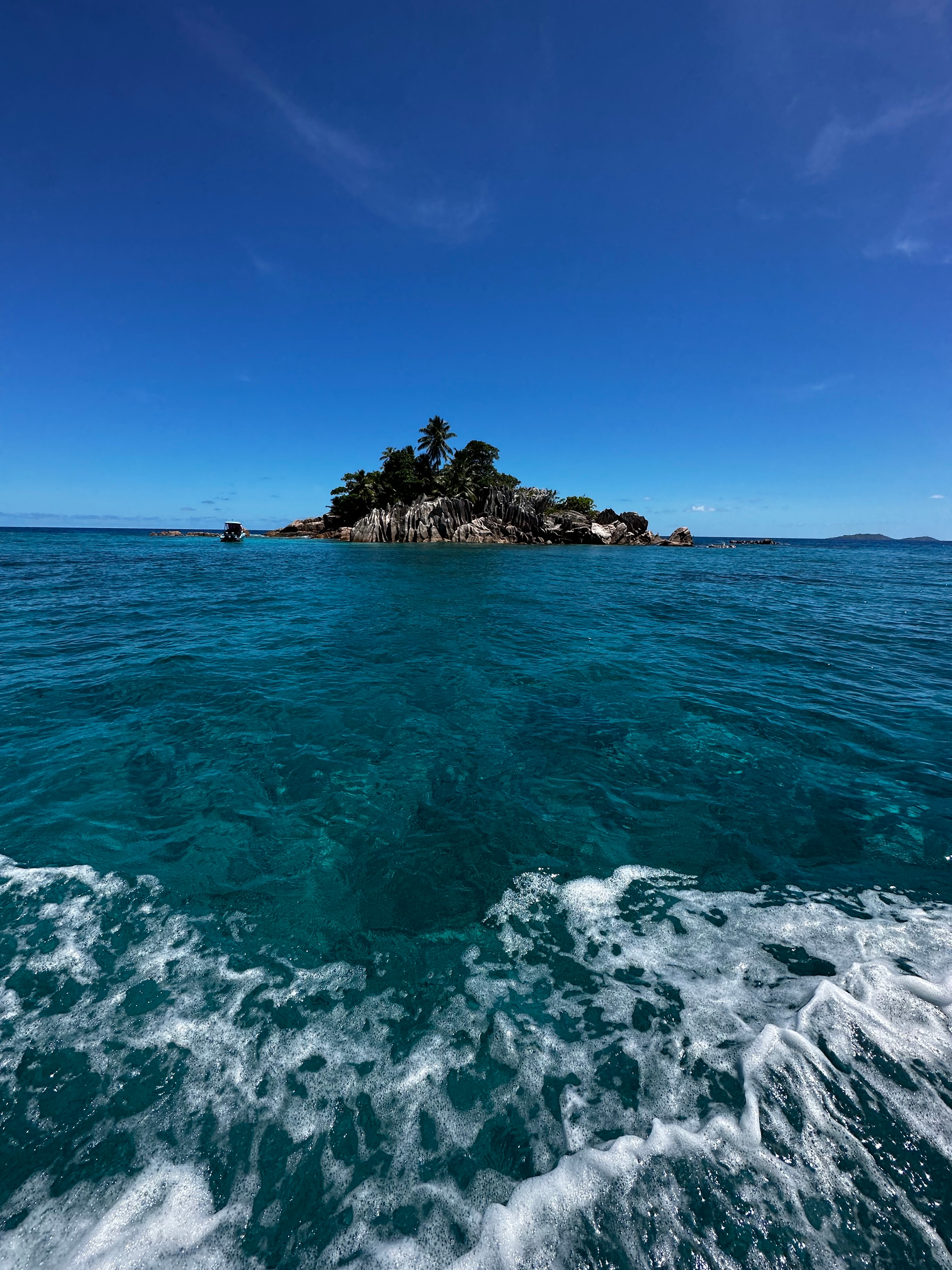 Image of the ocean with a rock formation in the distance. 