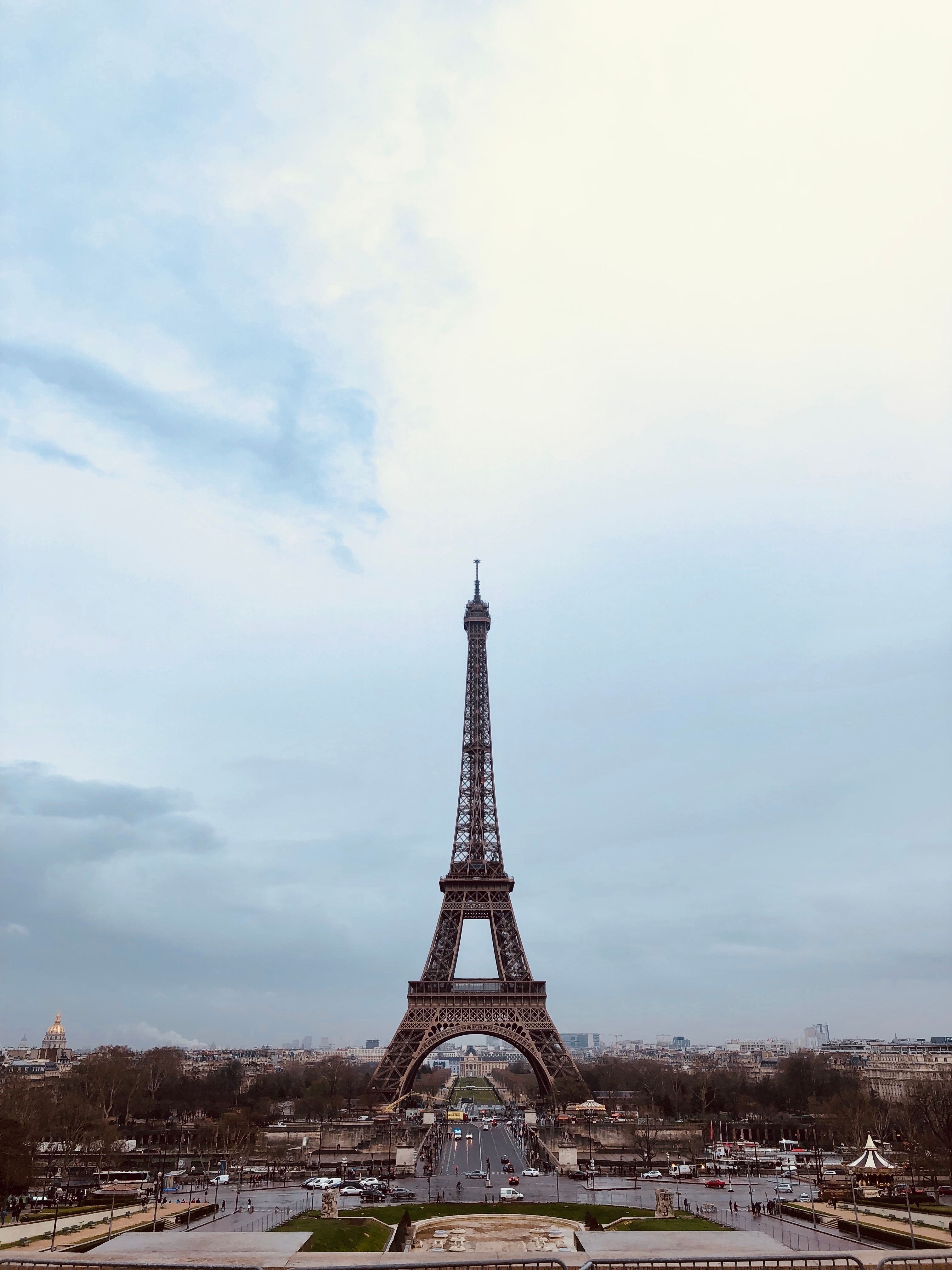 Pretty view of the Eiffel Tower from a distance under a slightly cloudy sky