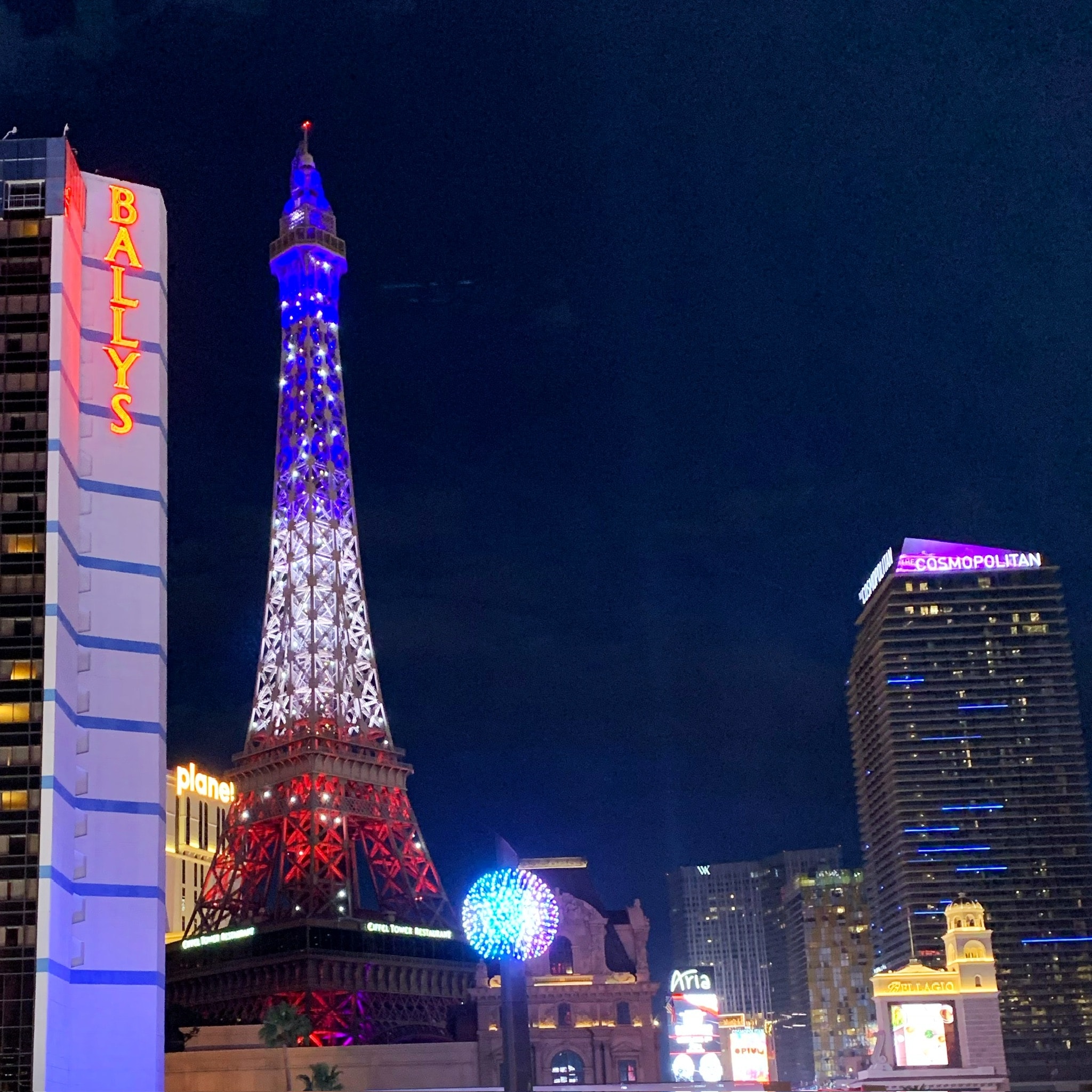 Night-time photo of tall, lit up buildings.