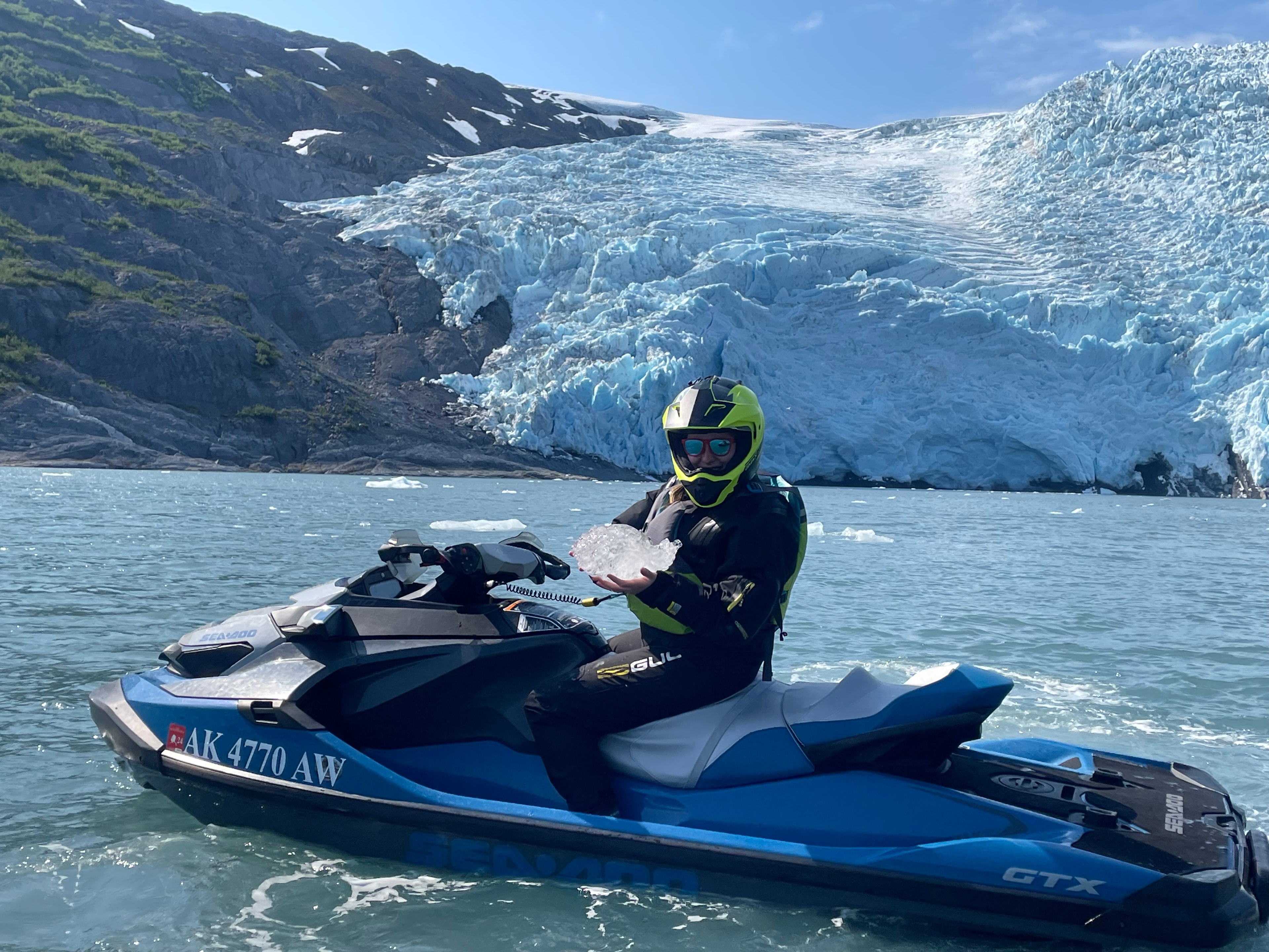 Jet skiing open waters surrounded by ice.