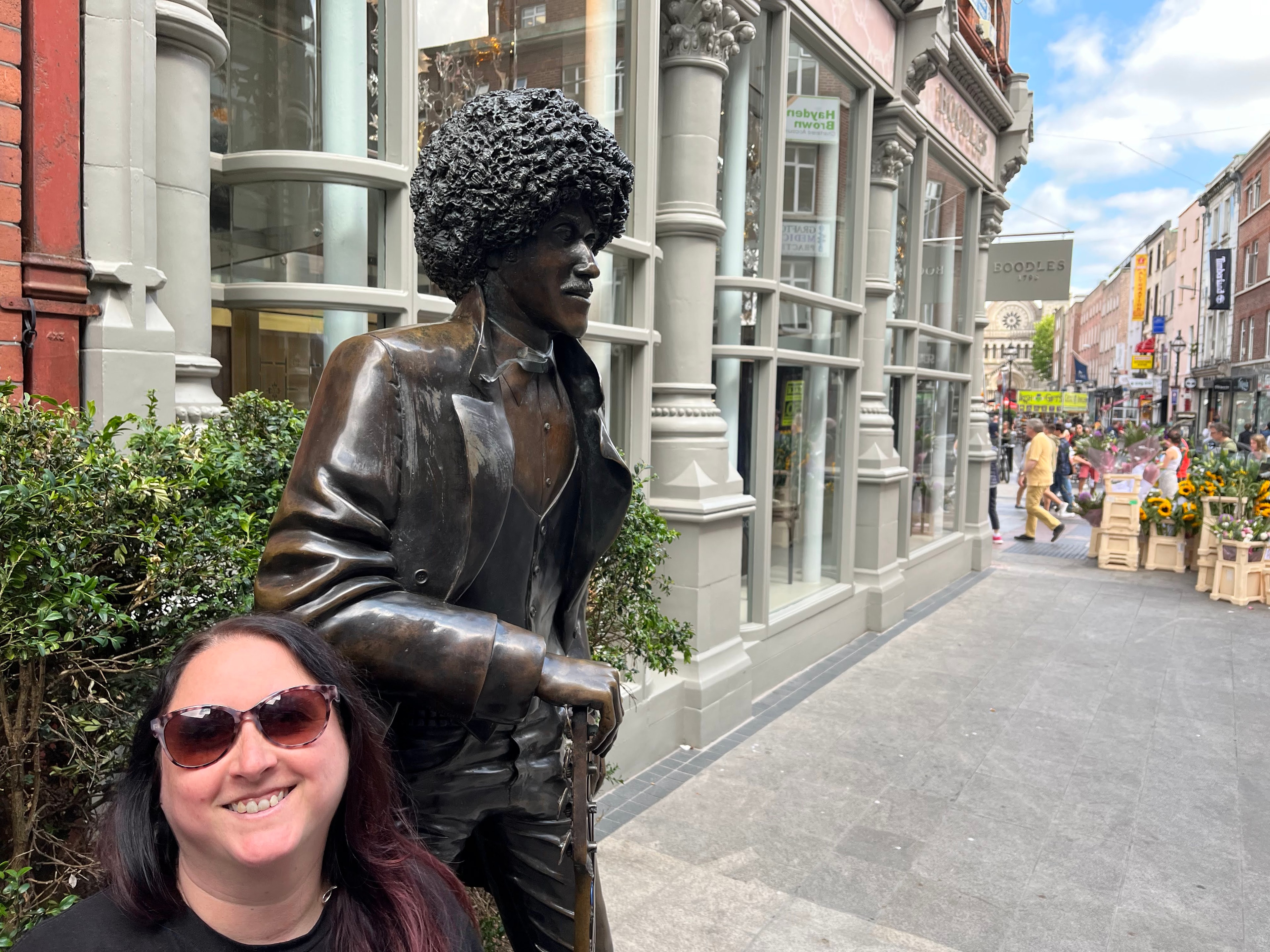 Advisor posing with a statue on a cute European street.