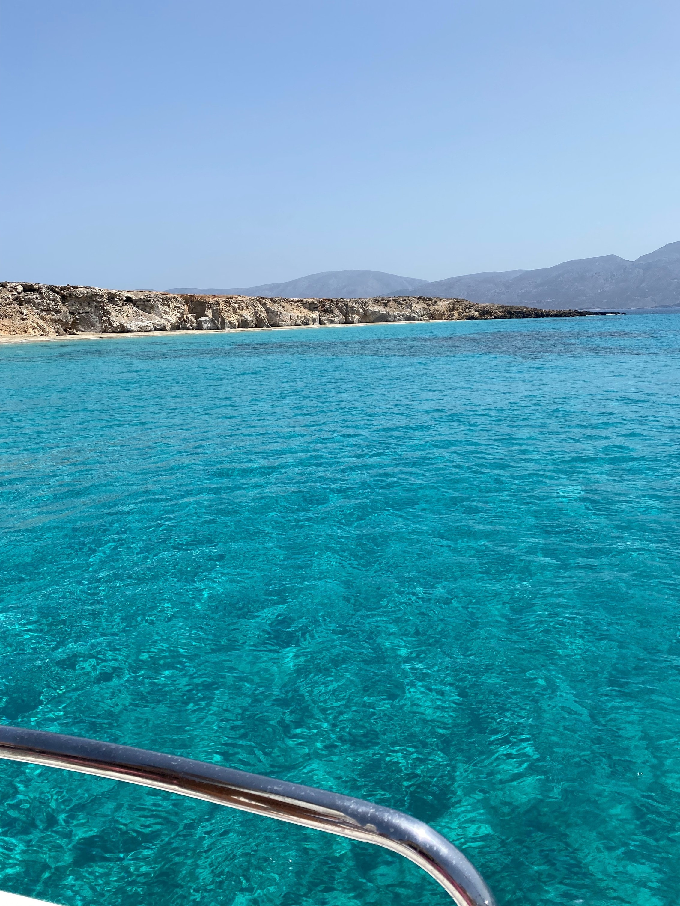 View of crystal clear blue ocean water from a boat