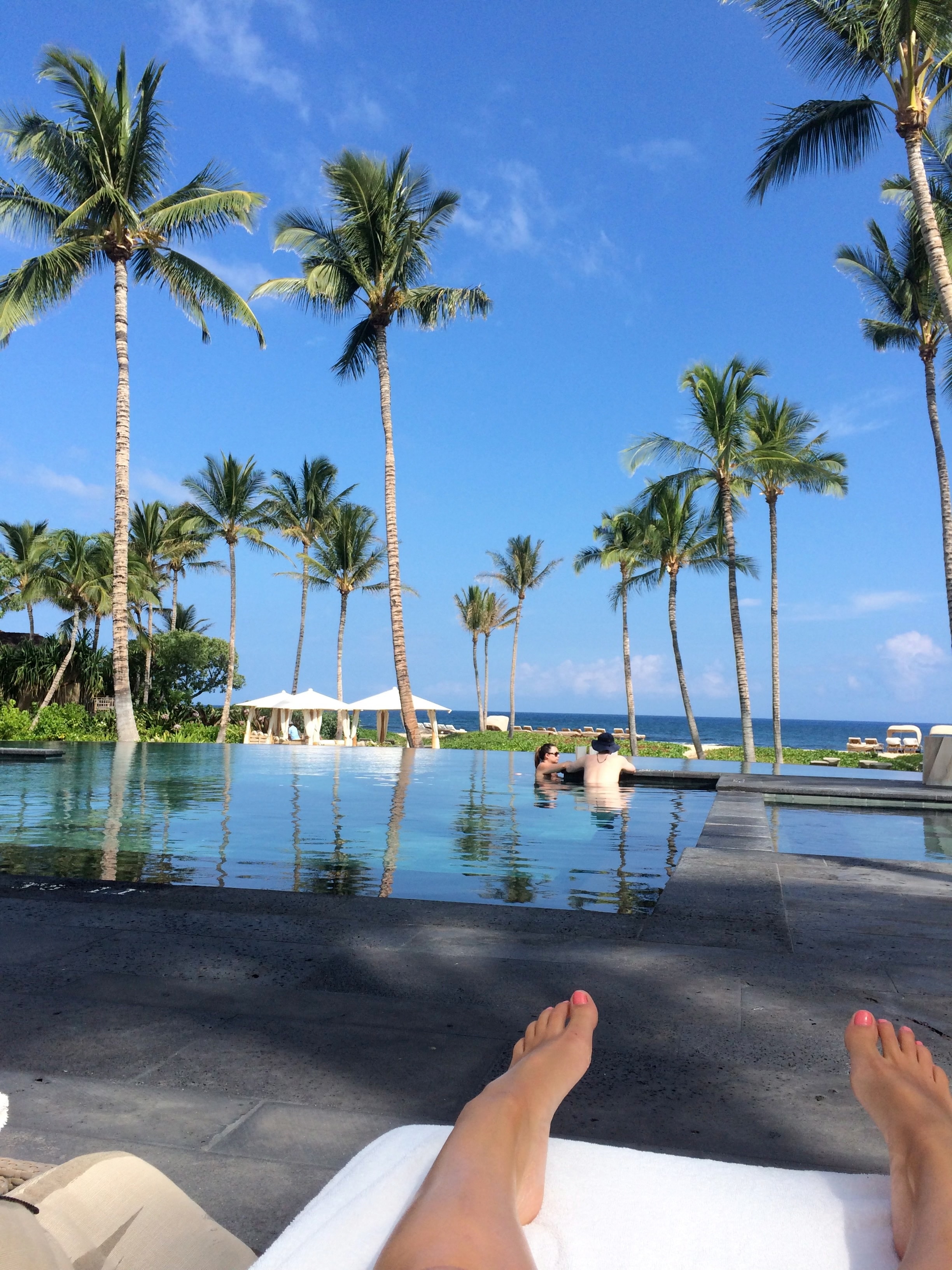 Advisor relaxing at a pool during the day.