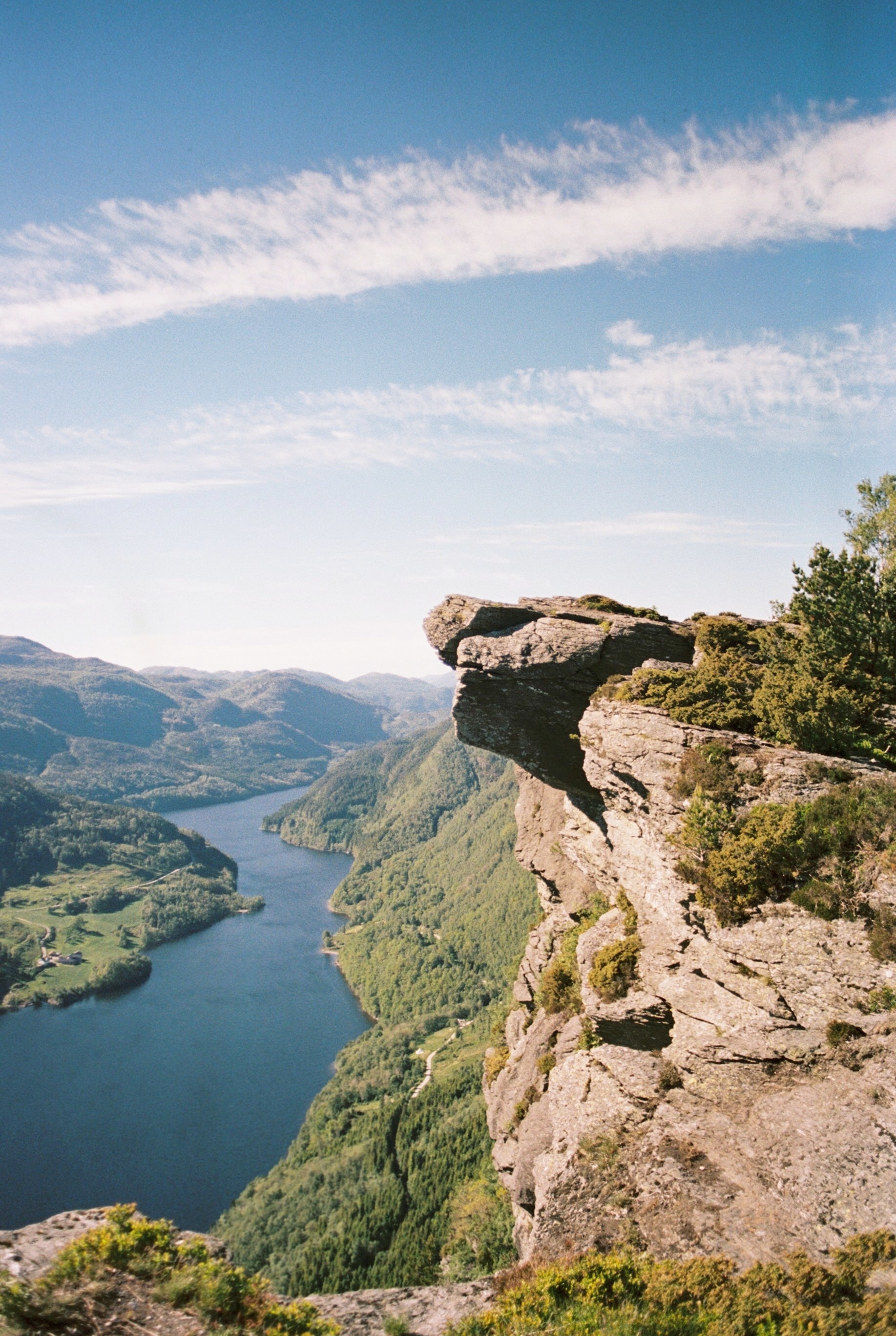 A view of the river with cliffs during the day. 