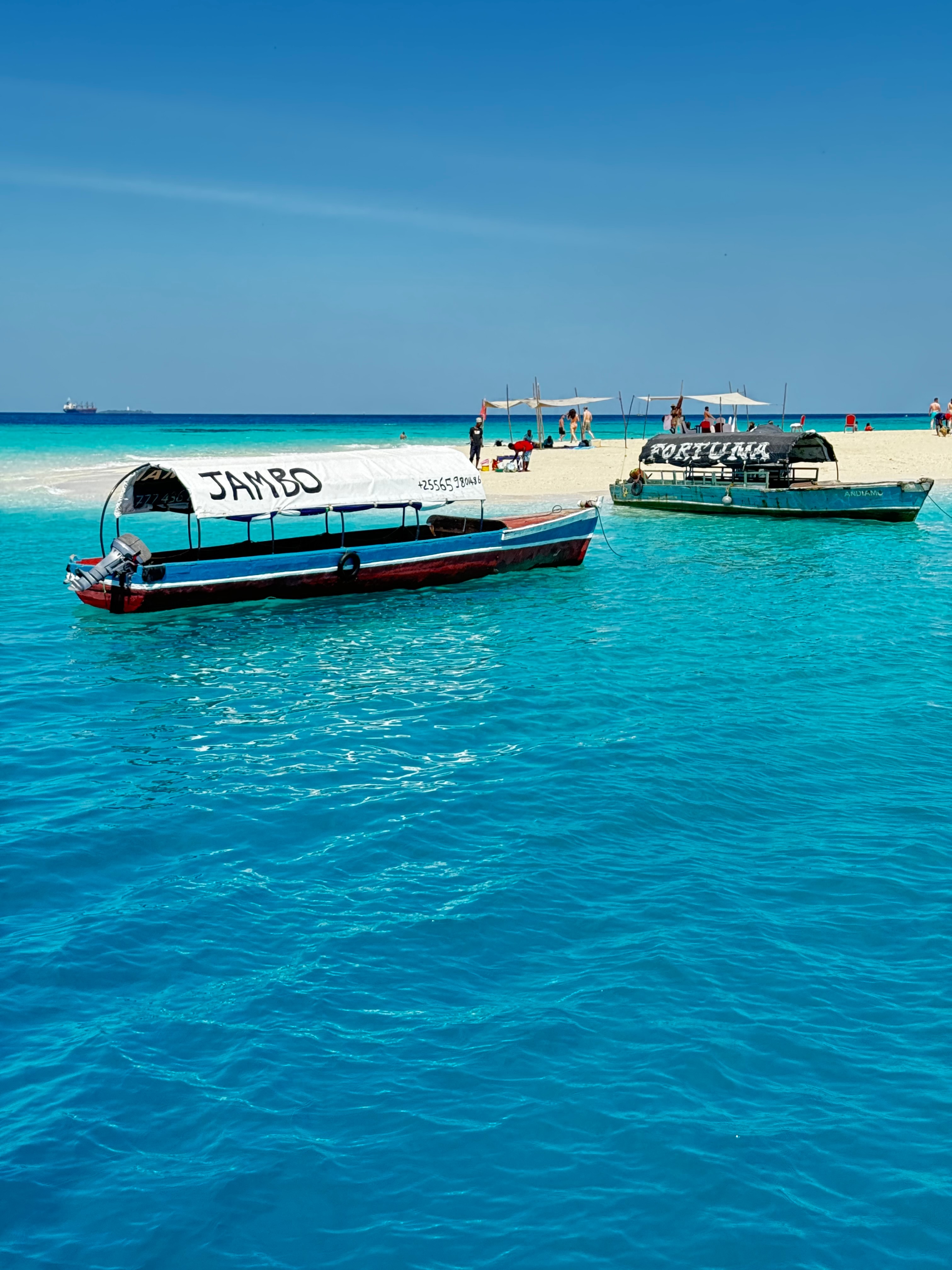 A view of a boat in clear water on a sunny day. 