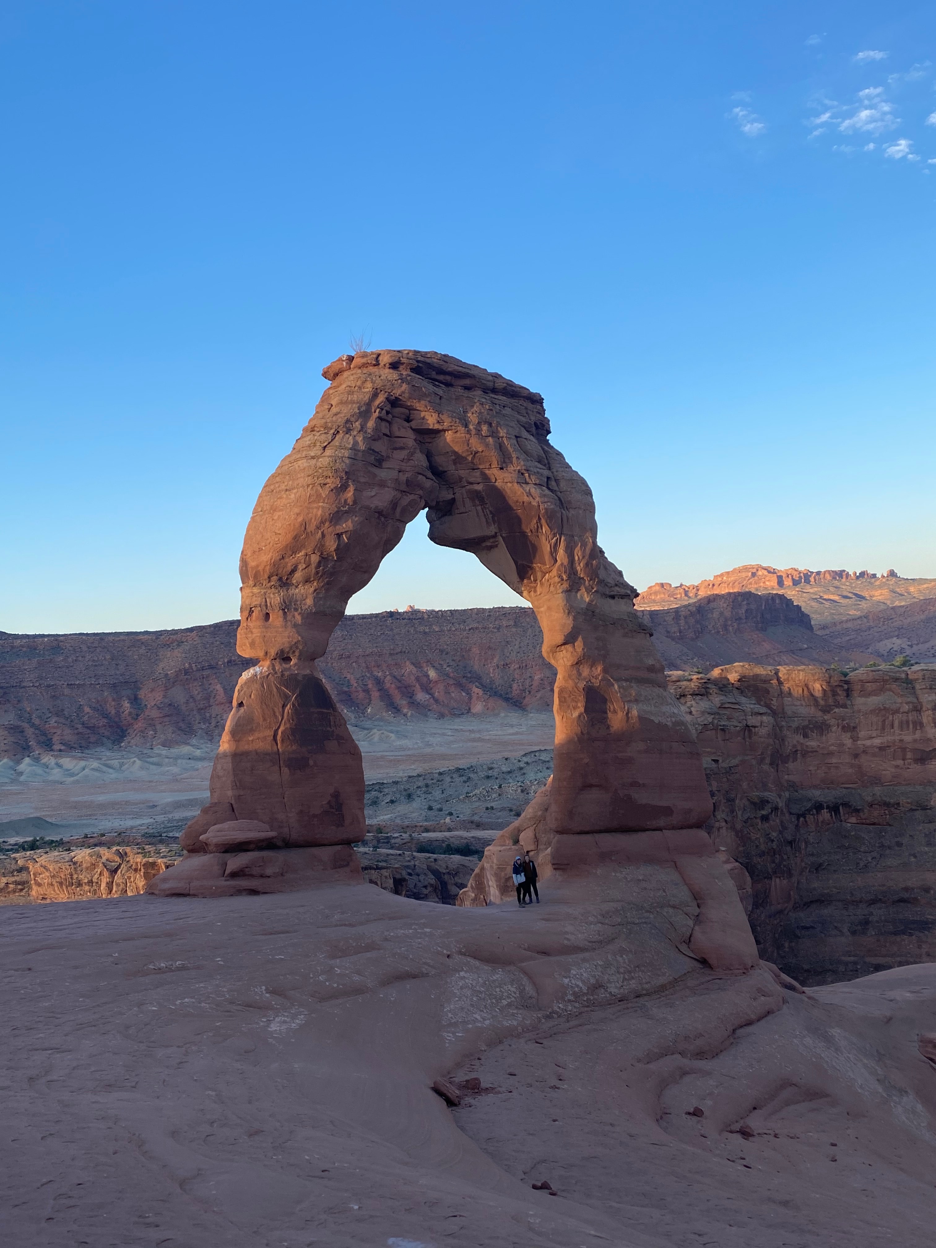 A view of rock formations in the desert at dusk. 