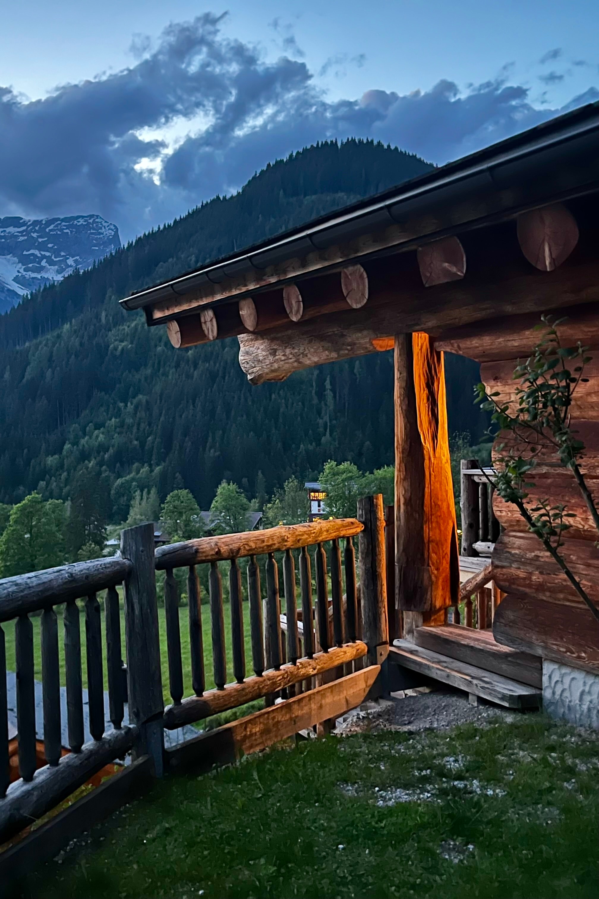 View of a wooden temple-like building amidst the mountains at dusk