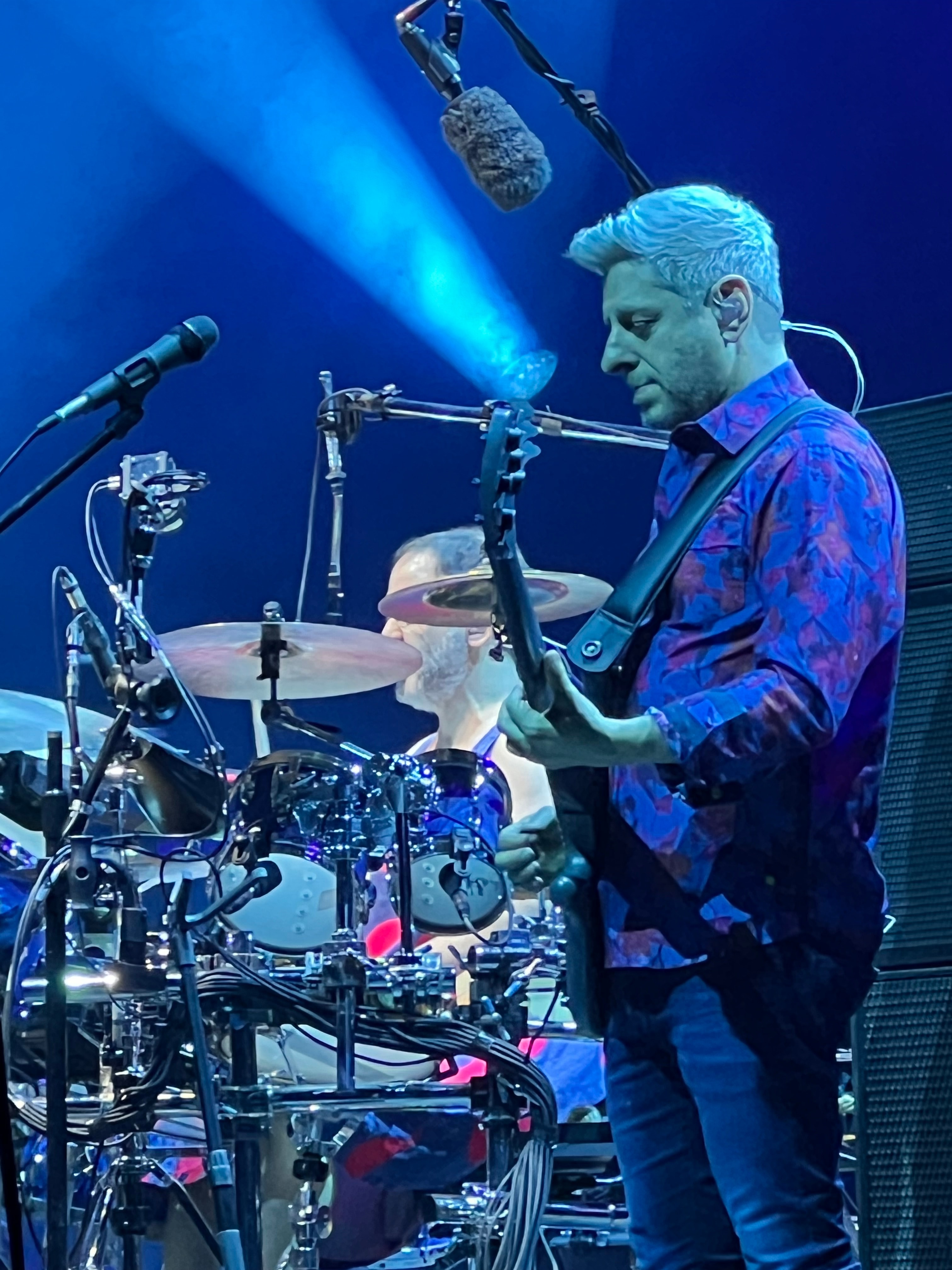 View of a guitarist performing on stage during a concert