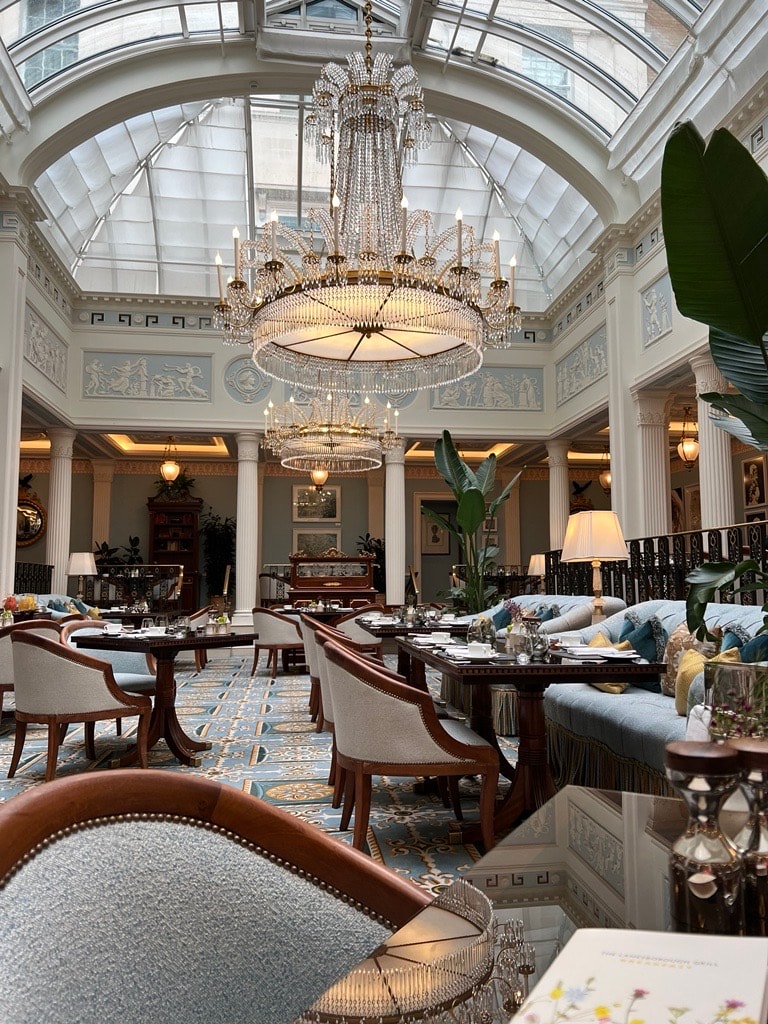 Beautiful interior of a hotel restaurant with a large chandelier and glass ceilings