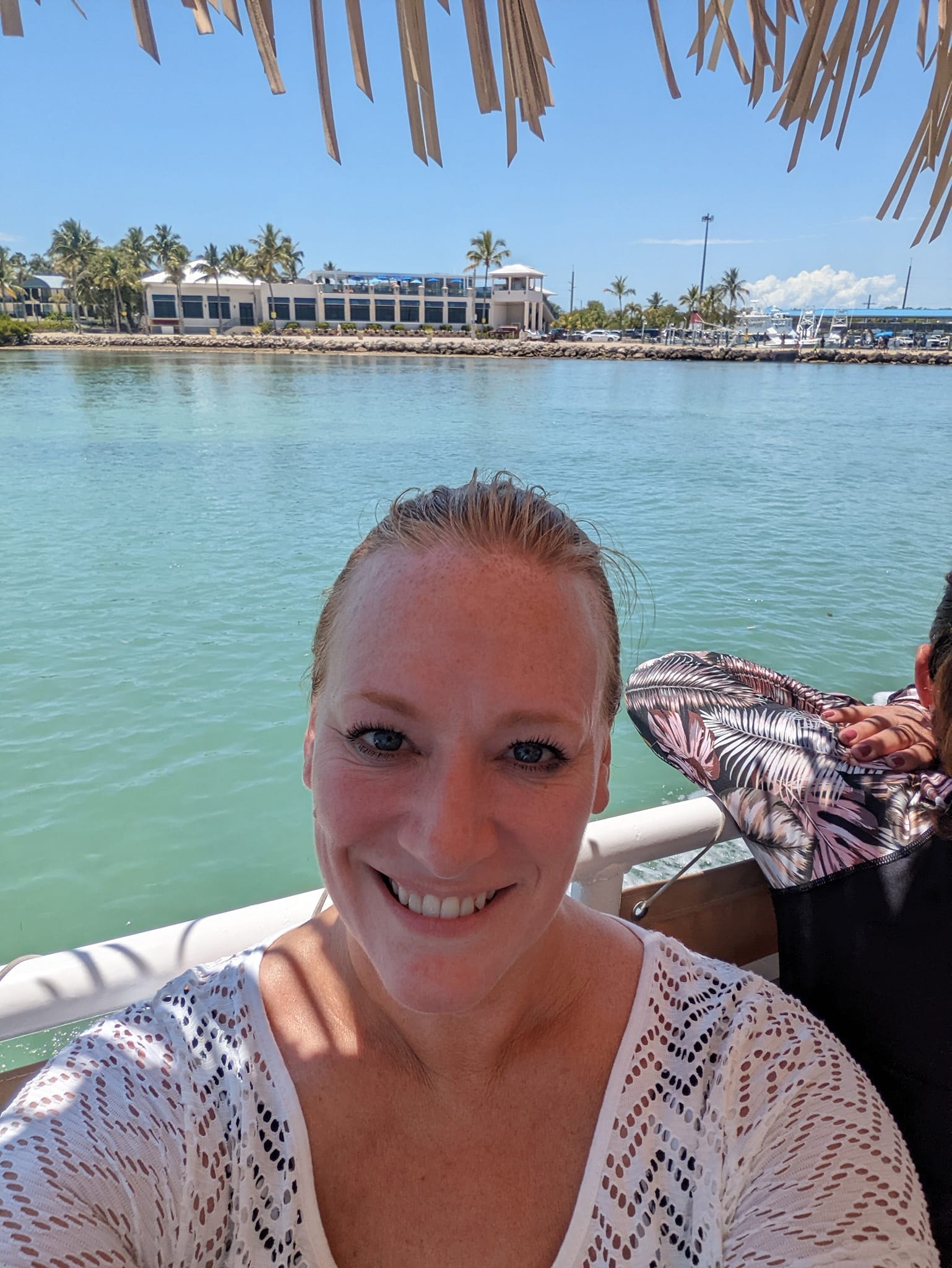 Advisor in a white shirt taking a selfie by the sea on a sunny day