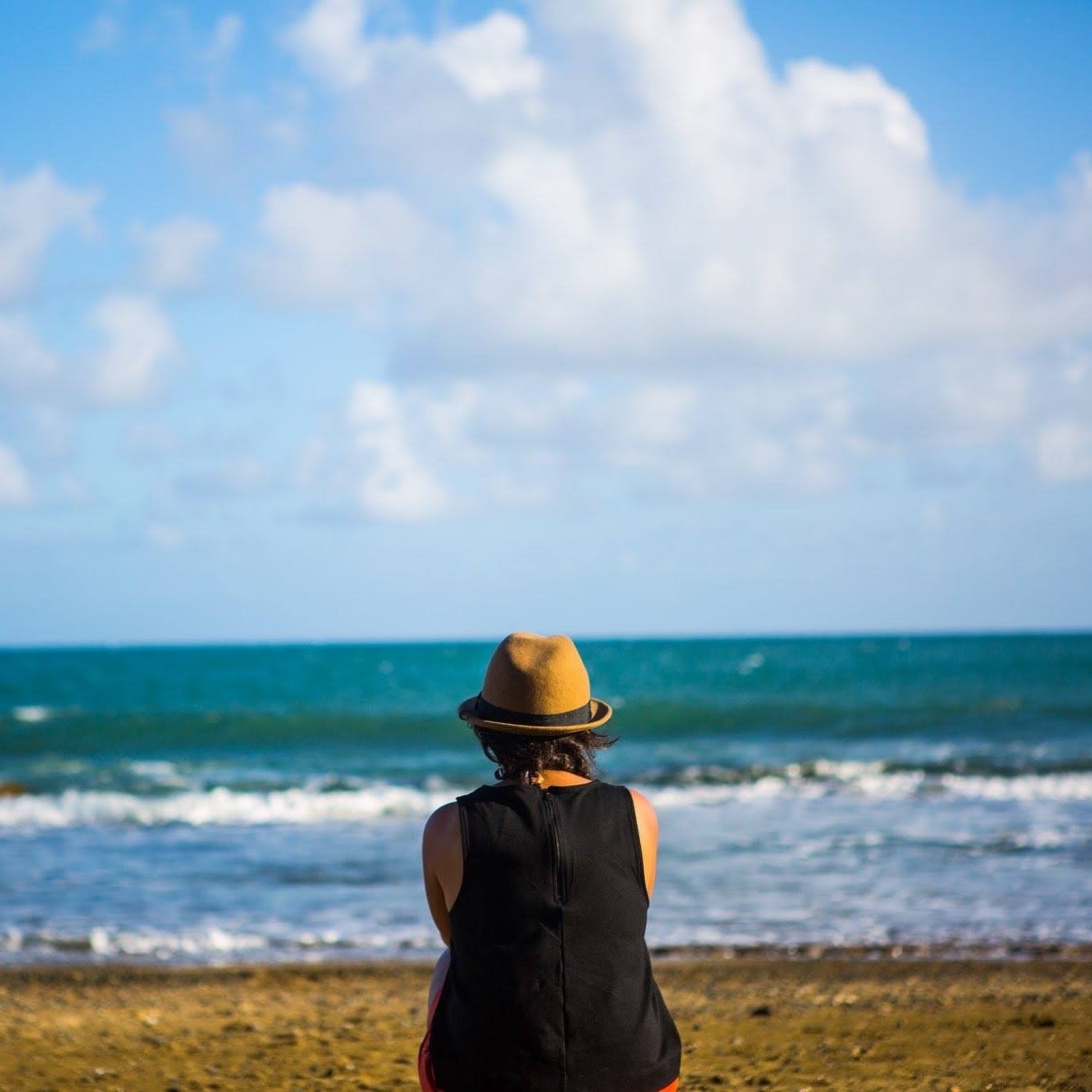 Advisor sitting on the beach looking out towards the ocean