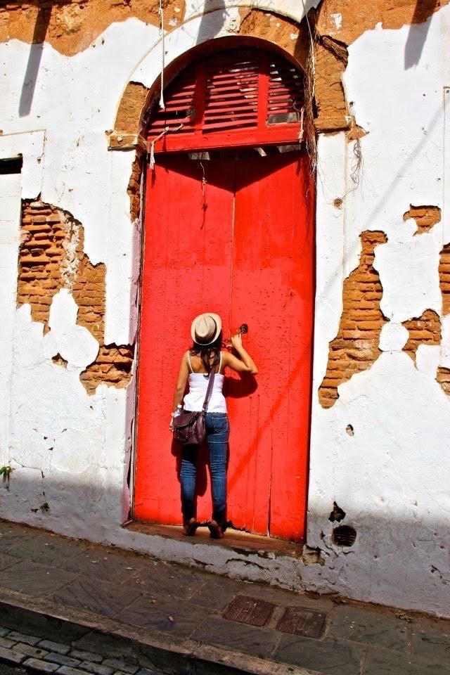 Advisor on an old city street beside a large red door