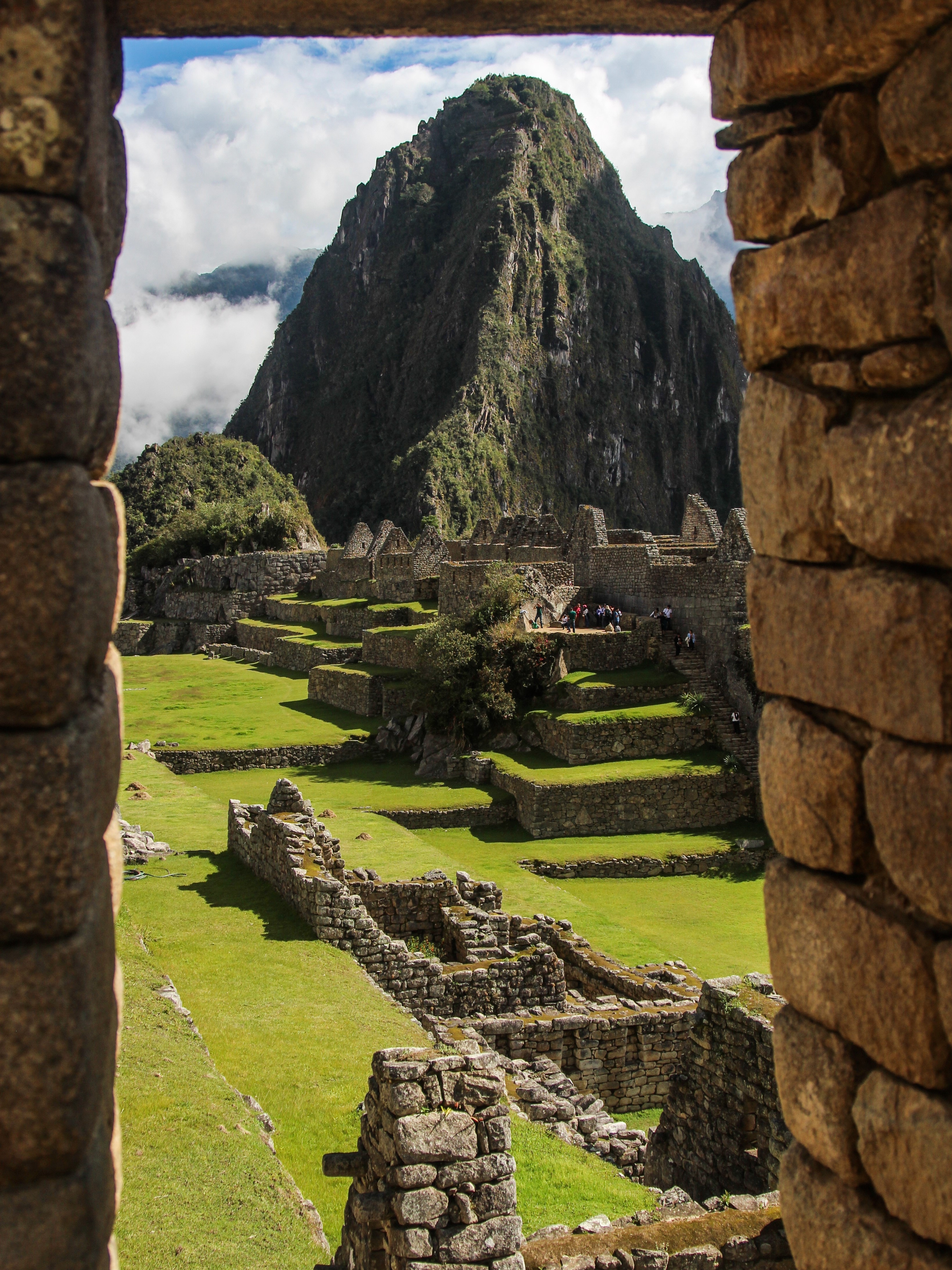 View of ruins at Machu Picchu seen through a stone window