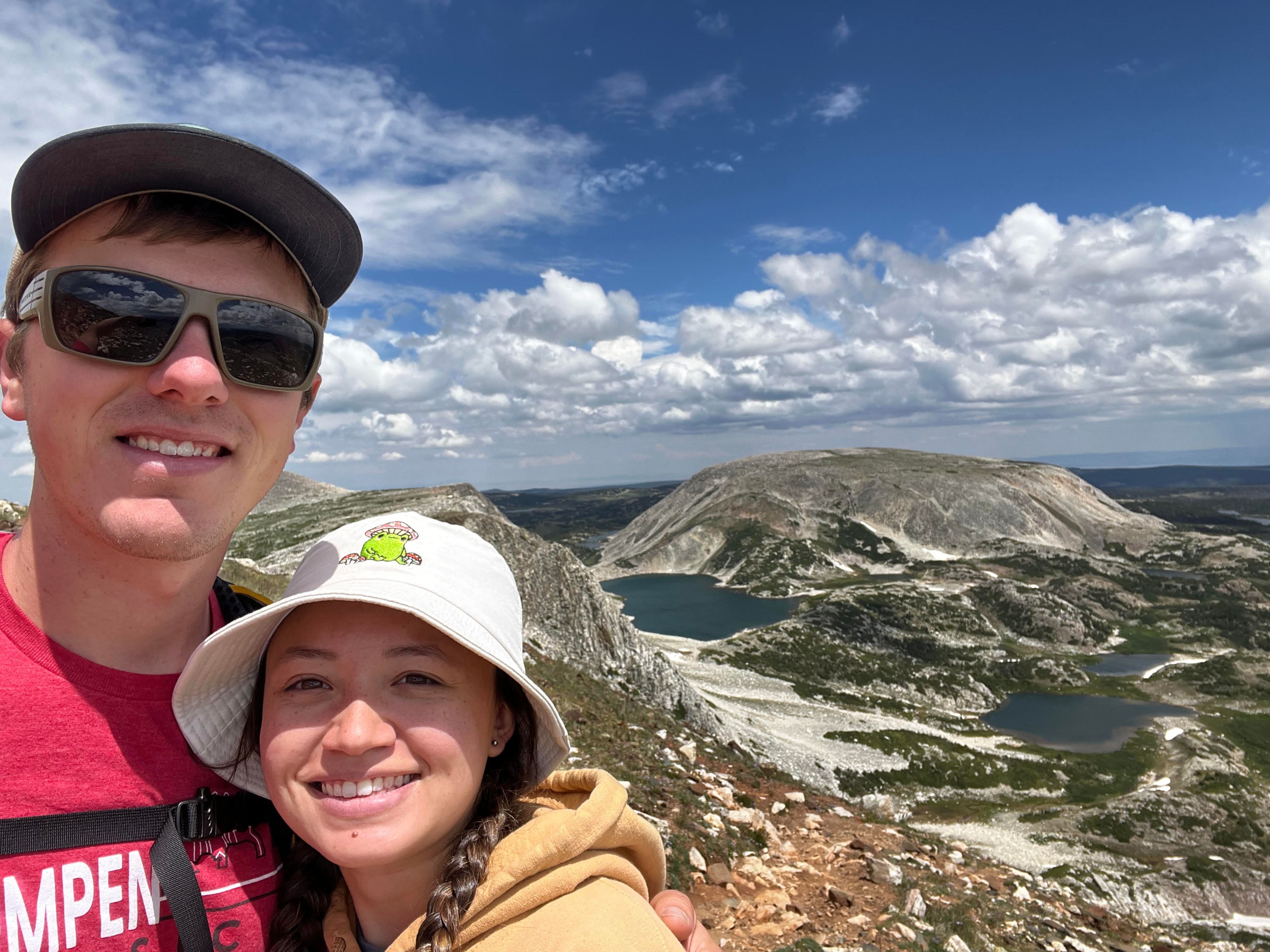 Advisor and partner on a hike overlooking a scenic valley on a sunny day