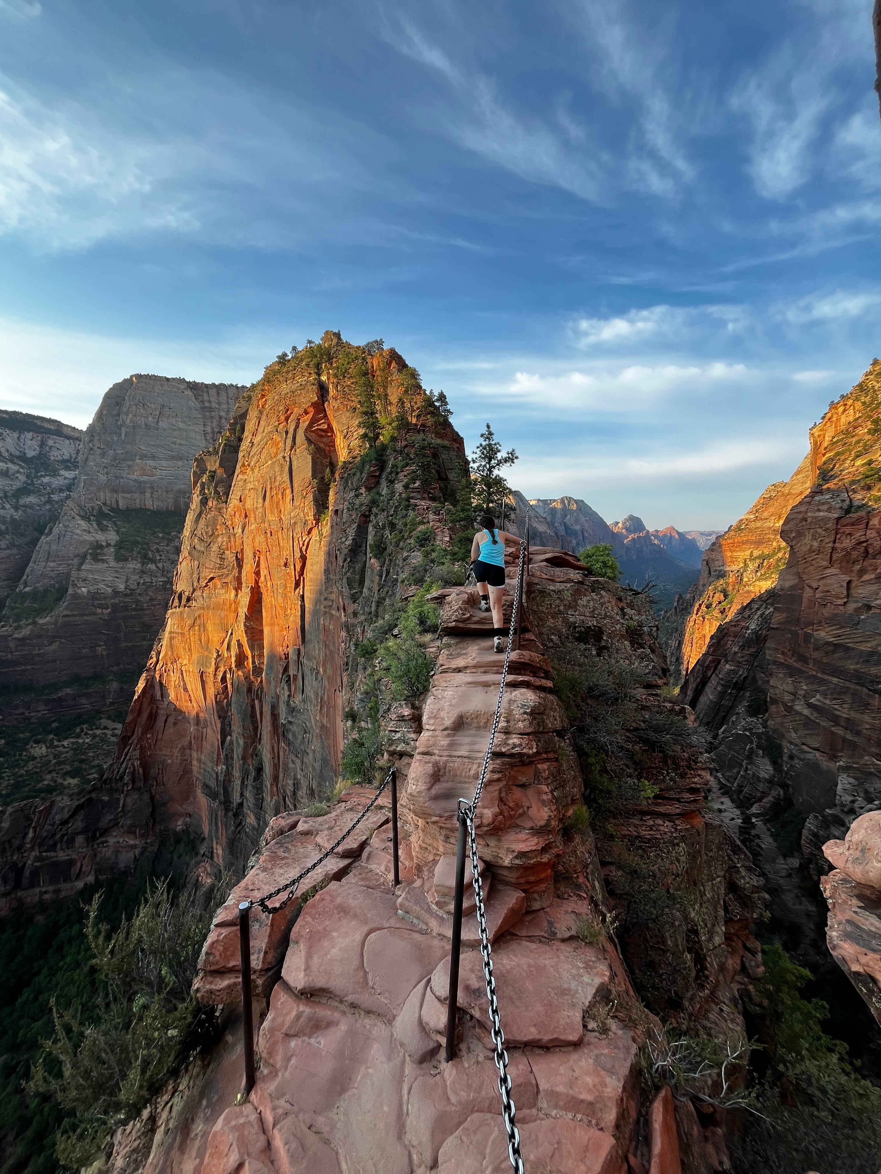 View of a beautiful hiking trail through steep cliffs under sunny skies