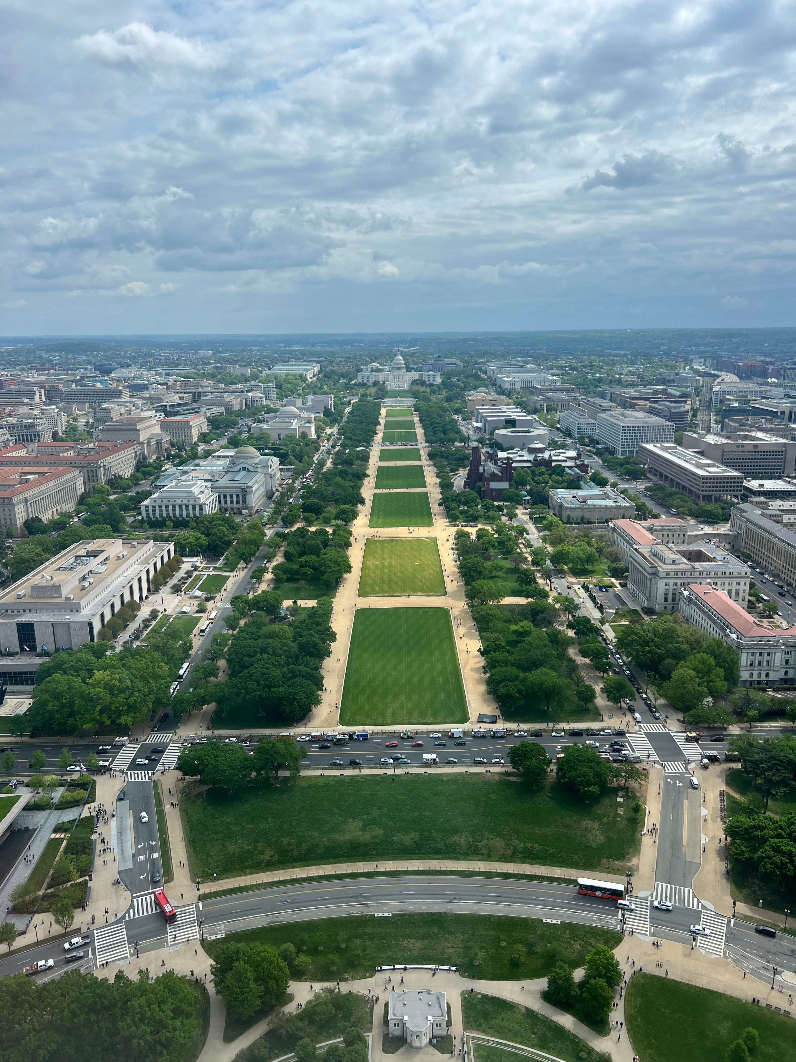 View from above of a long green lawn stretching out to sea on a cloudy day