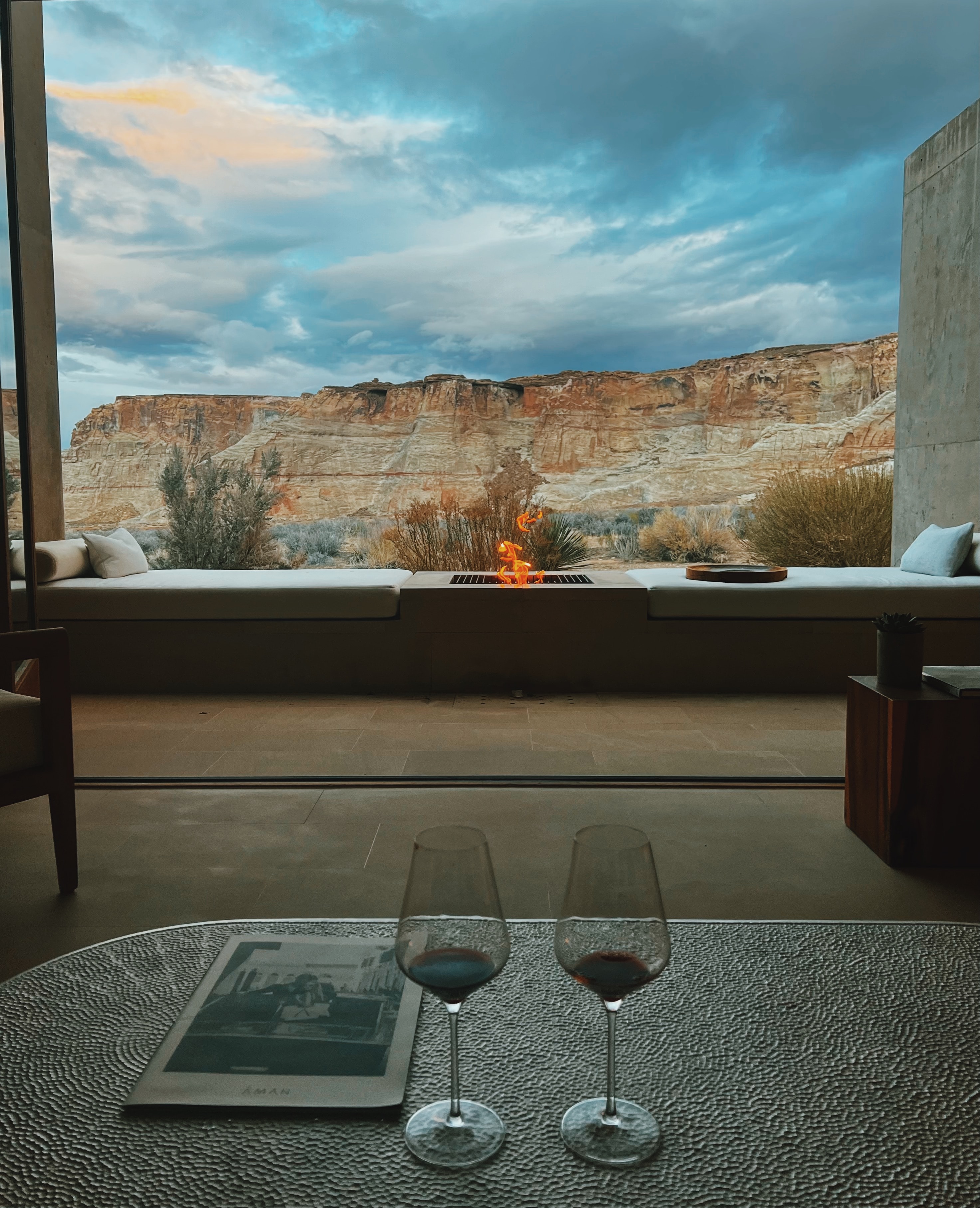 Two glasses of wine on a table overlooking a beautiful desert canyon