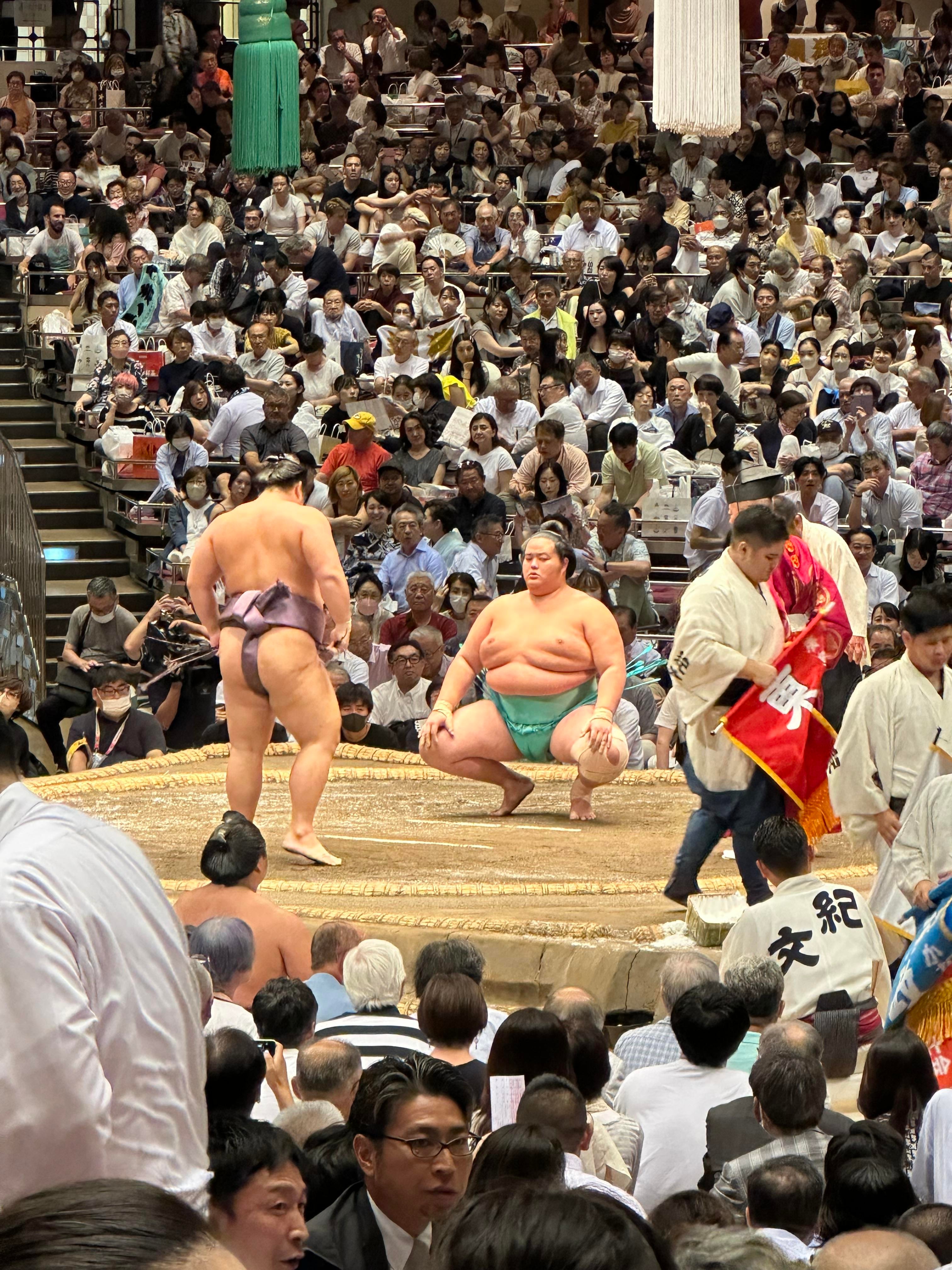 View of sumo wrestling in a packed stadium