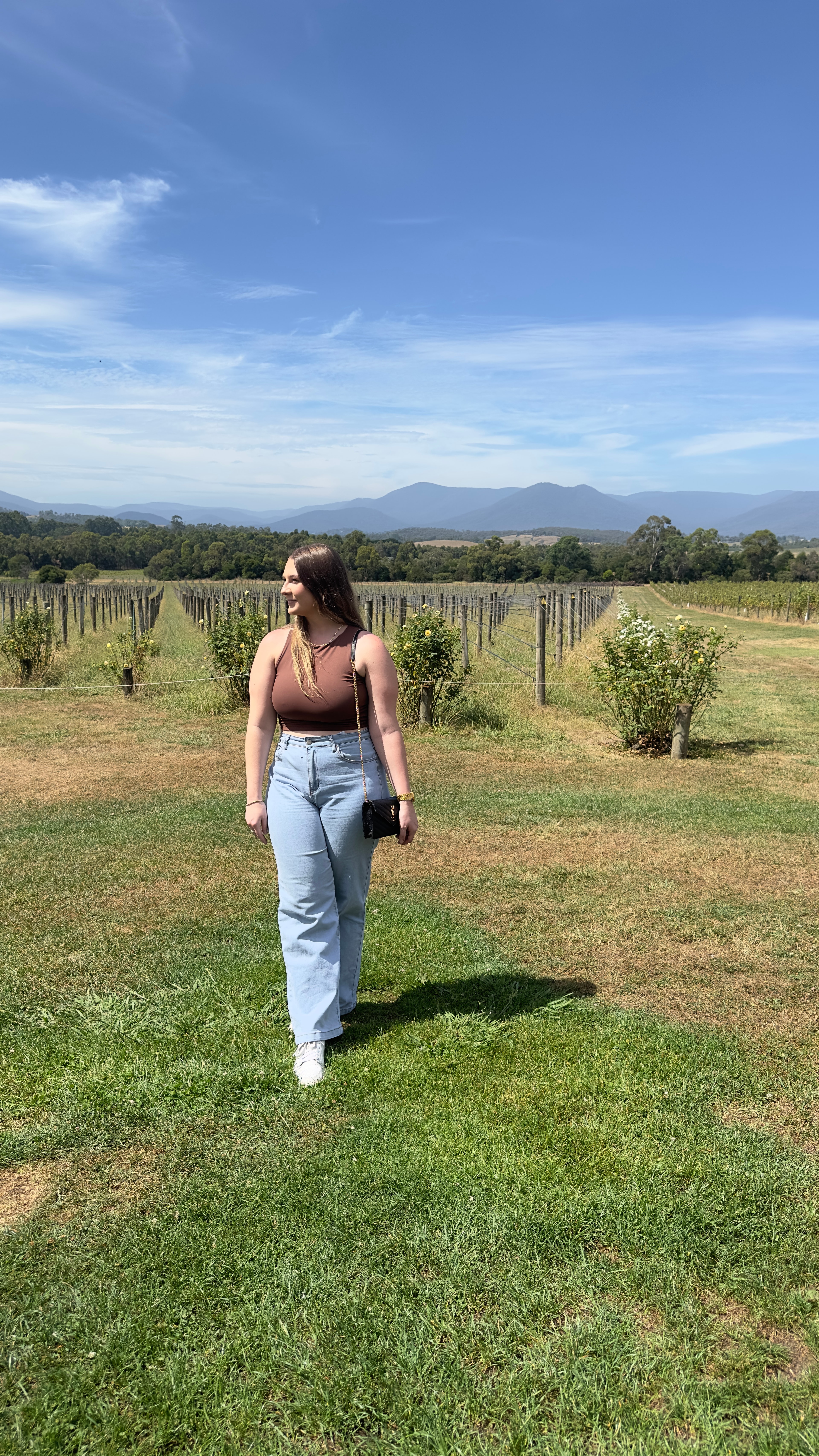 Advisor posing in an open field on a sunny day. 