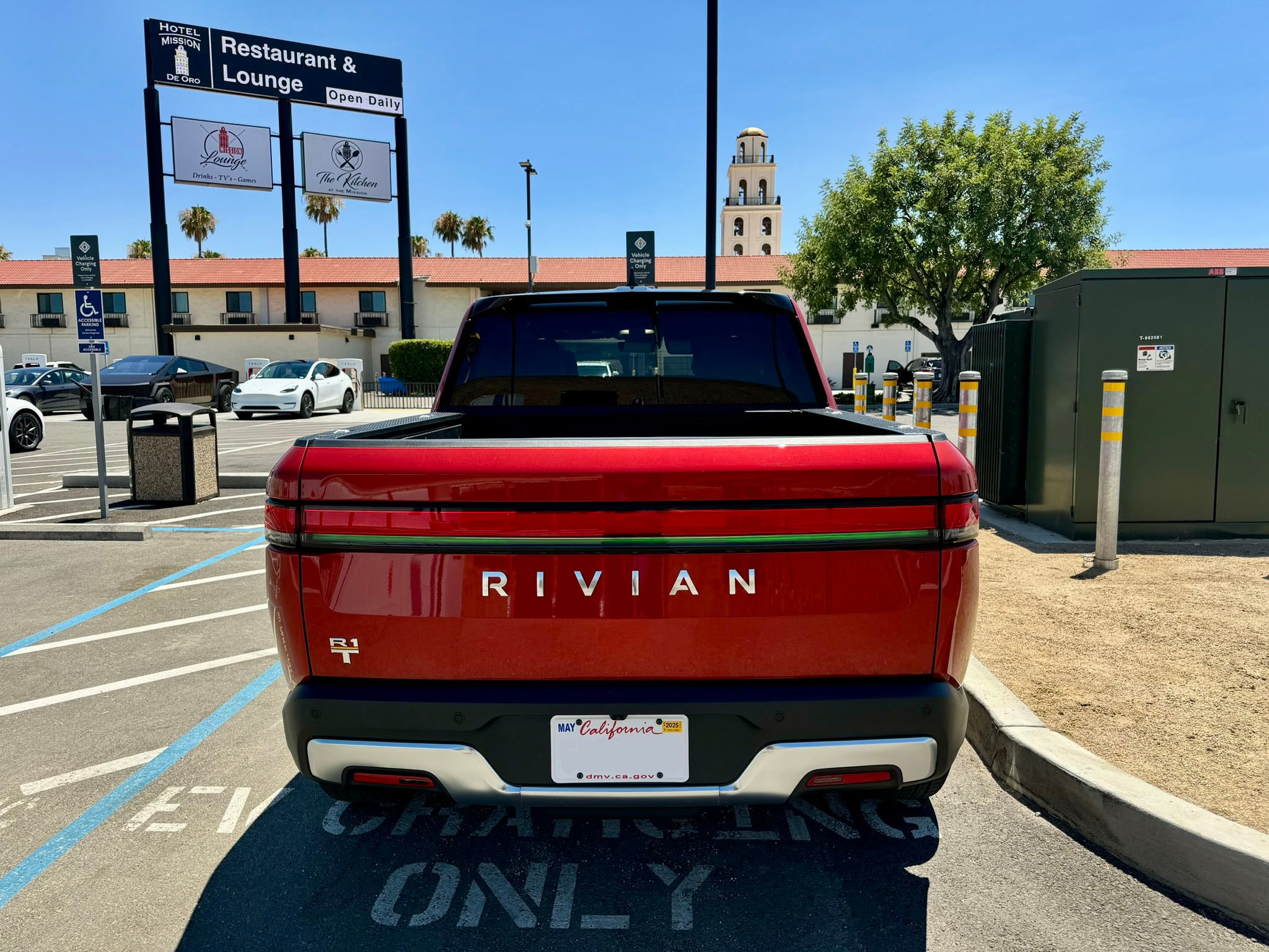 View of the back of a red pick up truck on a sunny day