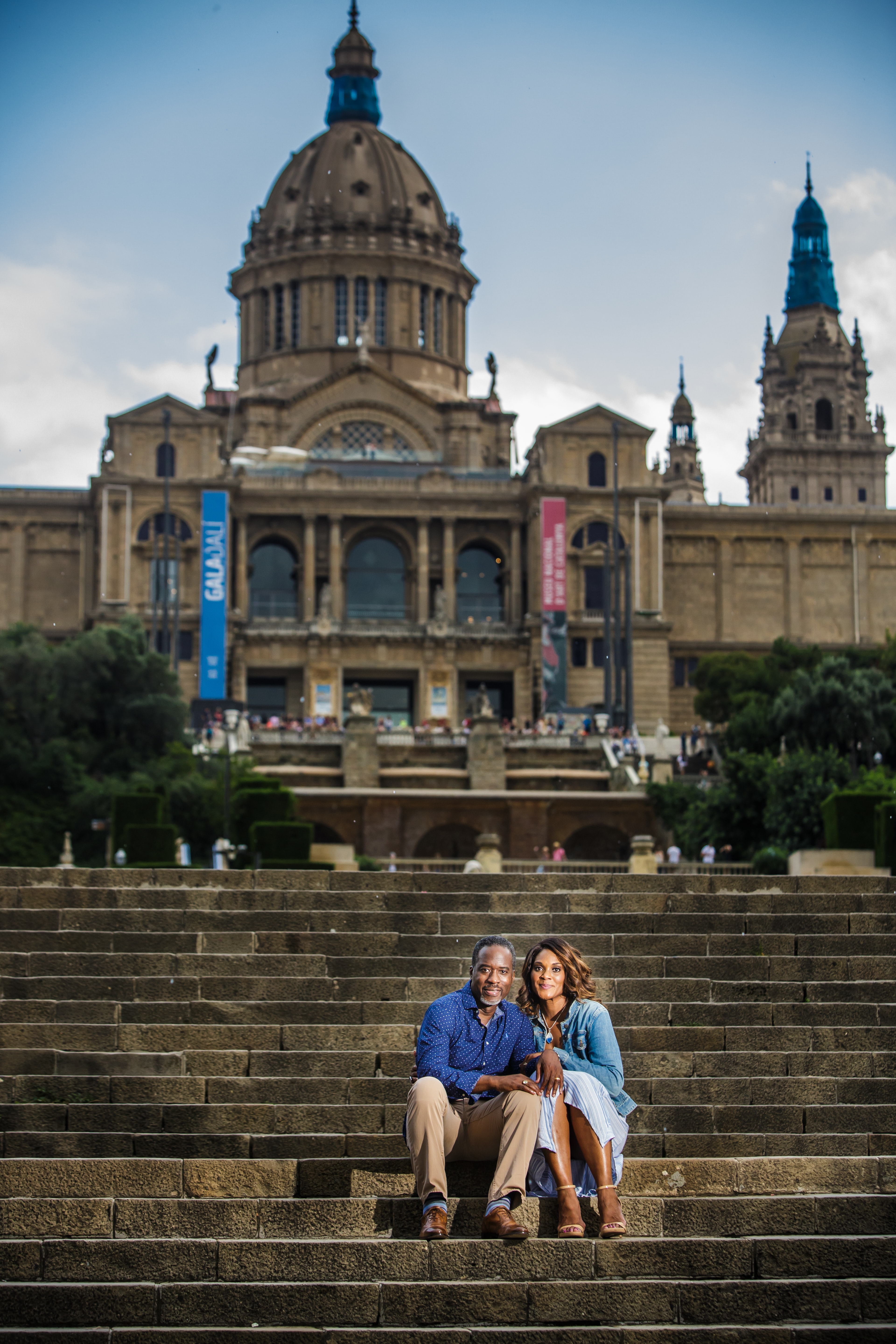 Advisor and wife sitting on a large outdoor staircase